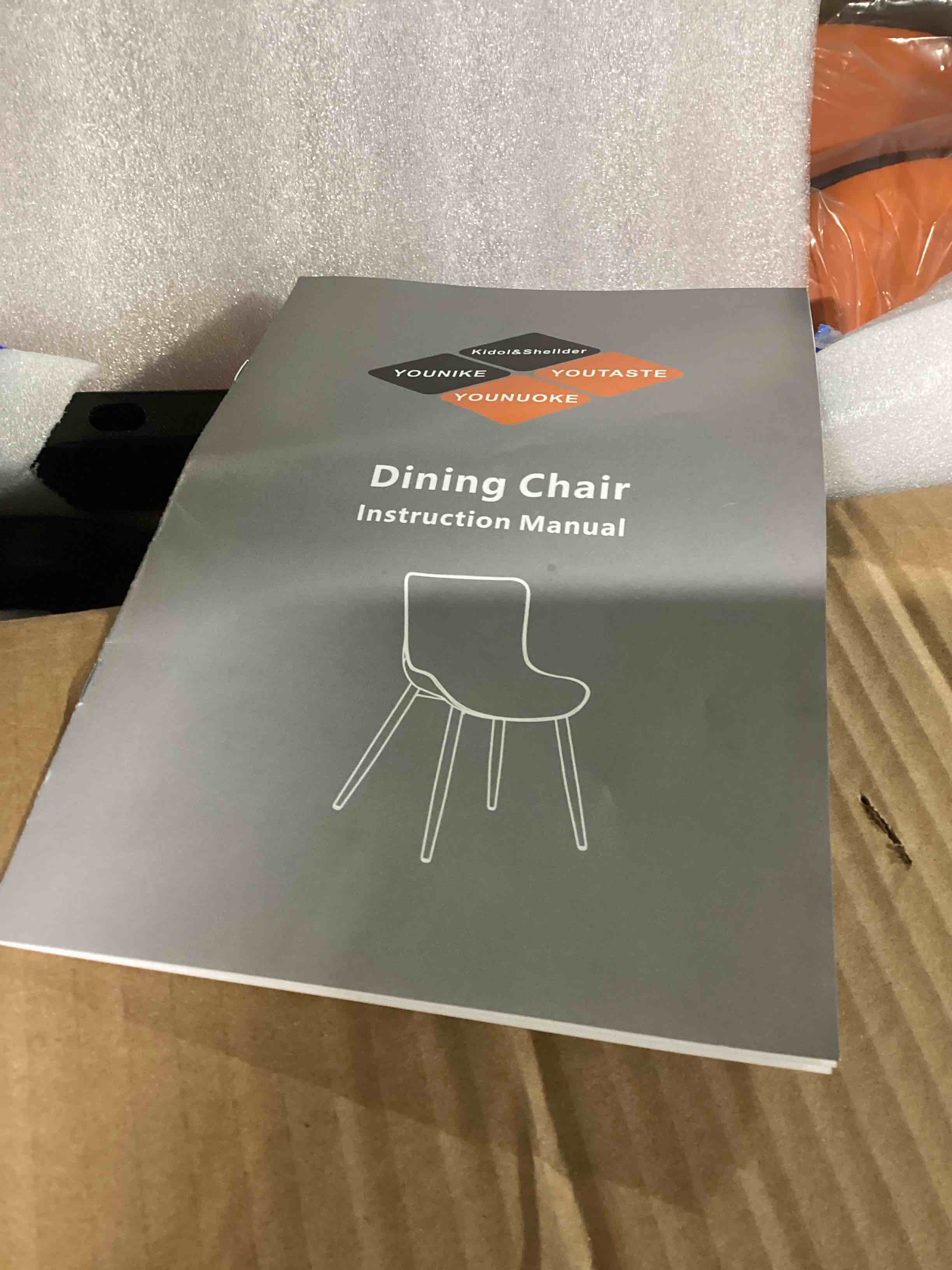 Condition photo showing Good Condition for set of 2 orange dining chairs with instructions and hardware