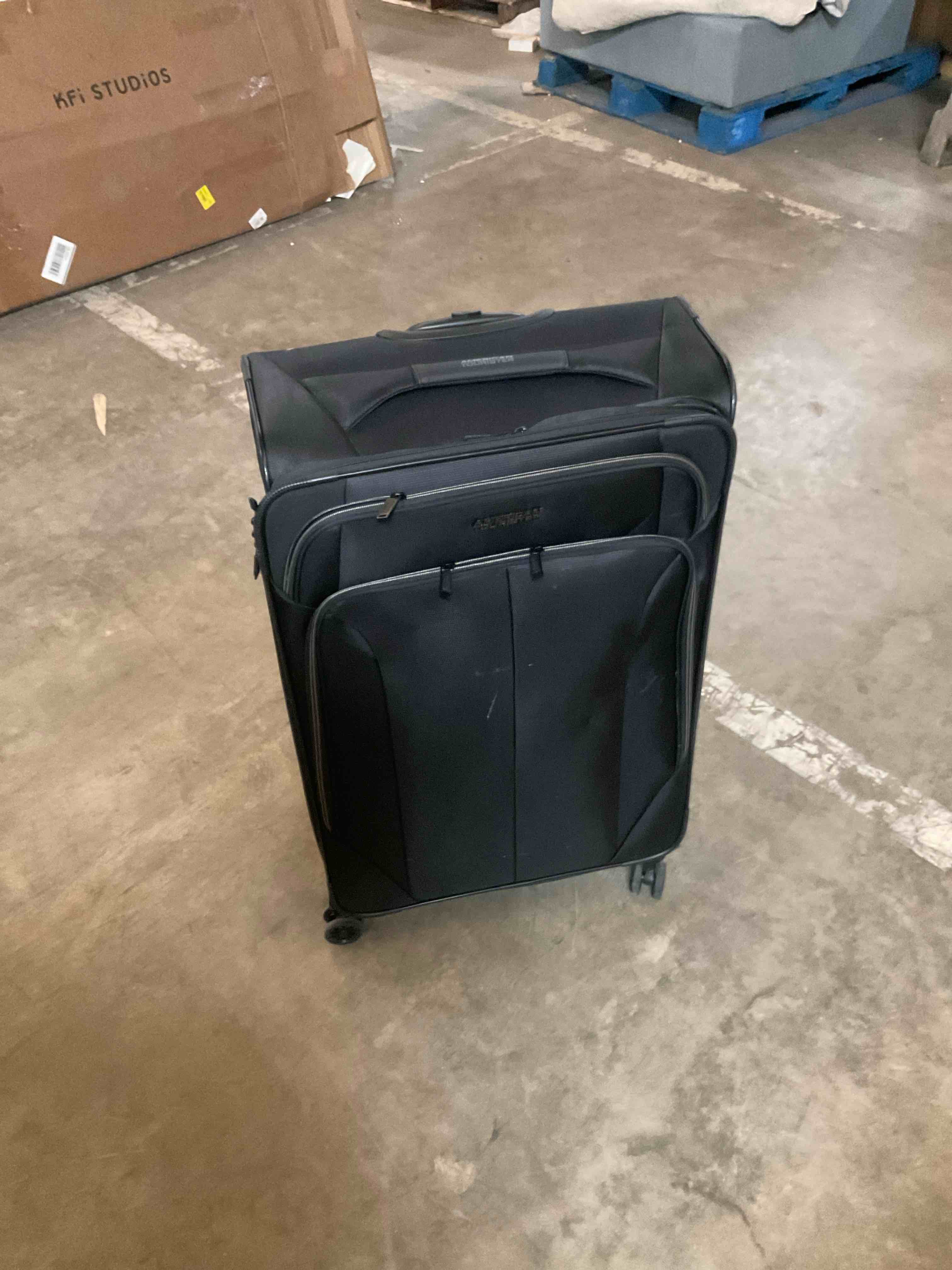 Condition photo showing Good Condition for American tourister rolling suitcase black 