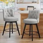 two grey upholstered swivel barstools