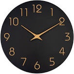 Large black clock with brass numbers