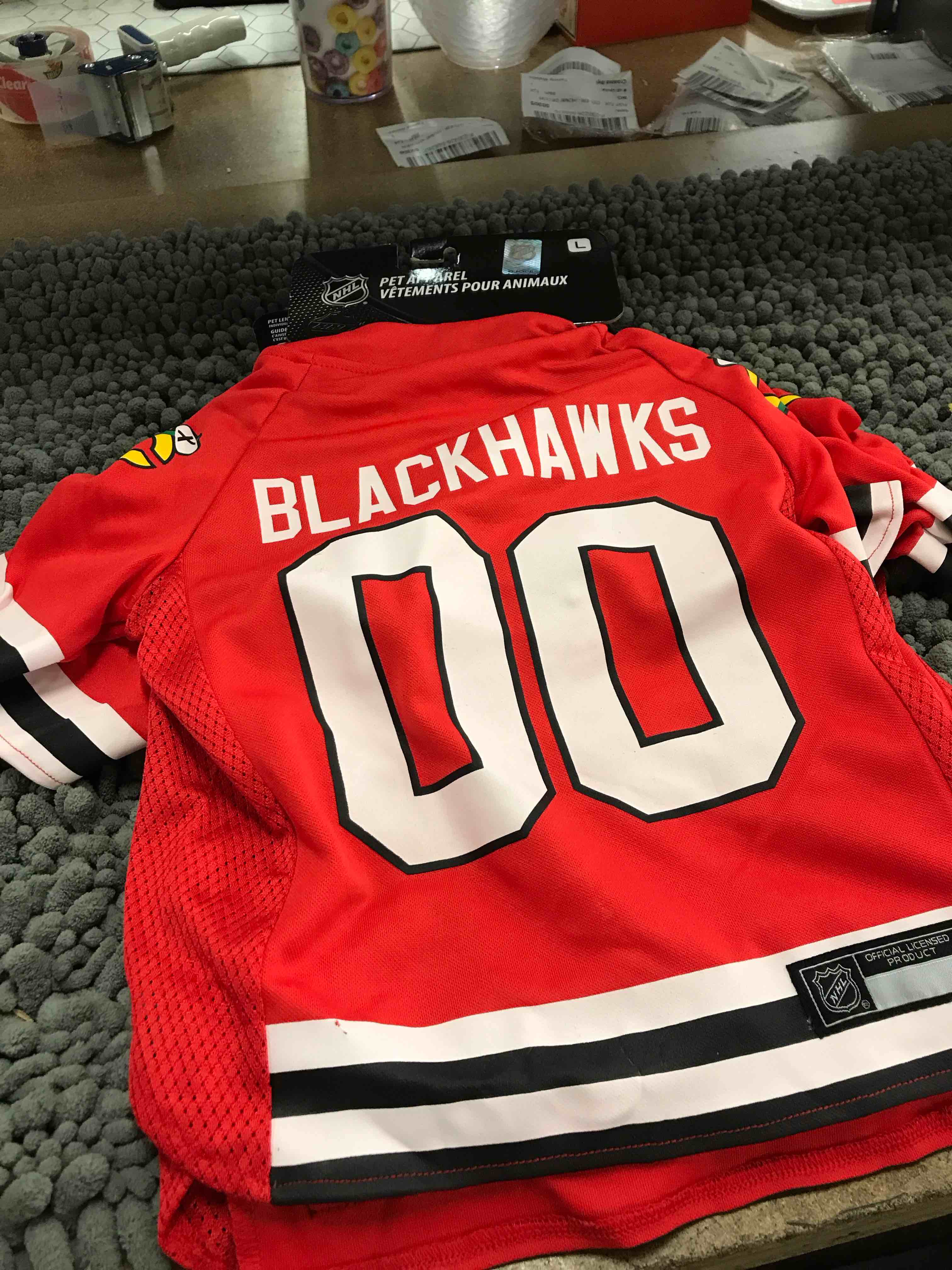 Condition photo showing New/Like New for size of blackhawks dog jersey