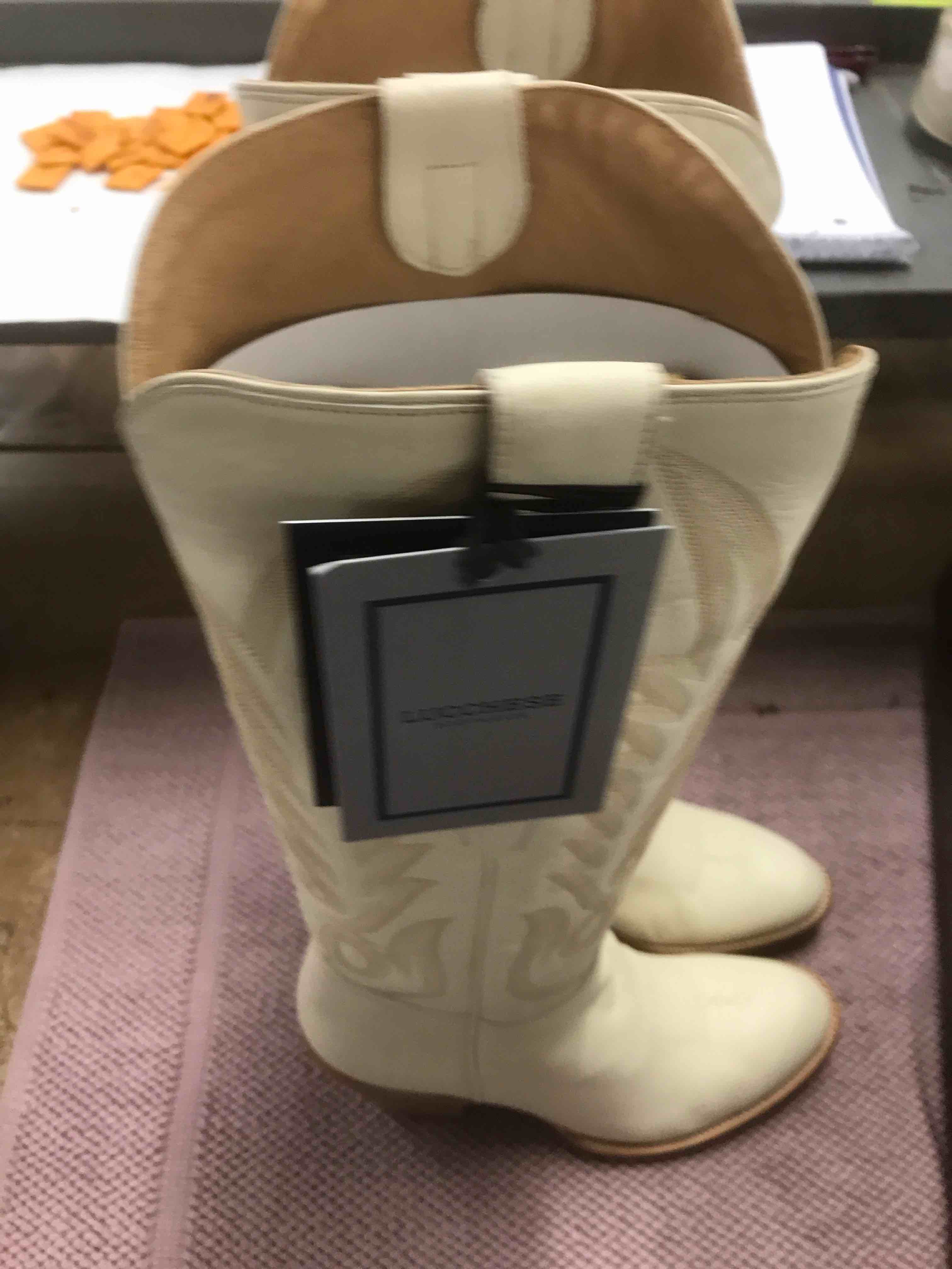 Condition photo showing As Is for Lucchese CR Cow 17” Tall Western.    Size 10B