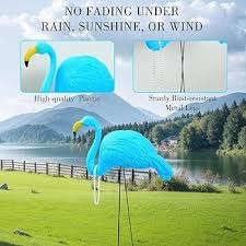 2 blue flamingos with pearls stand for yard decor. 