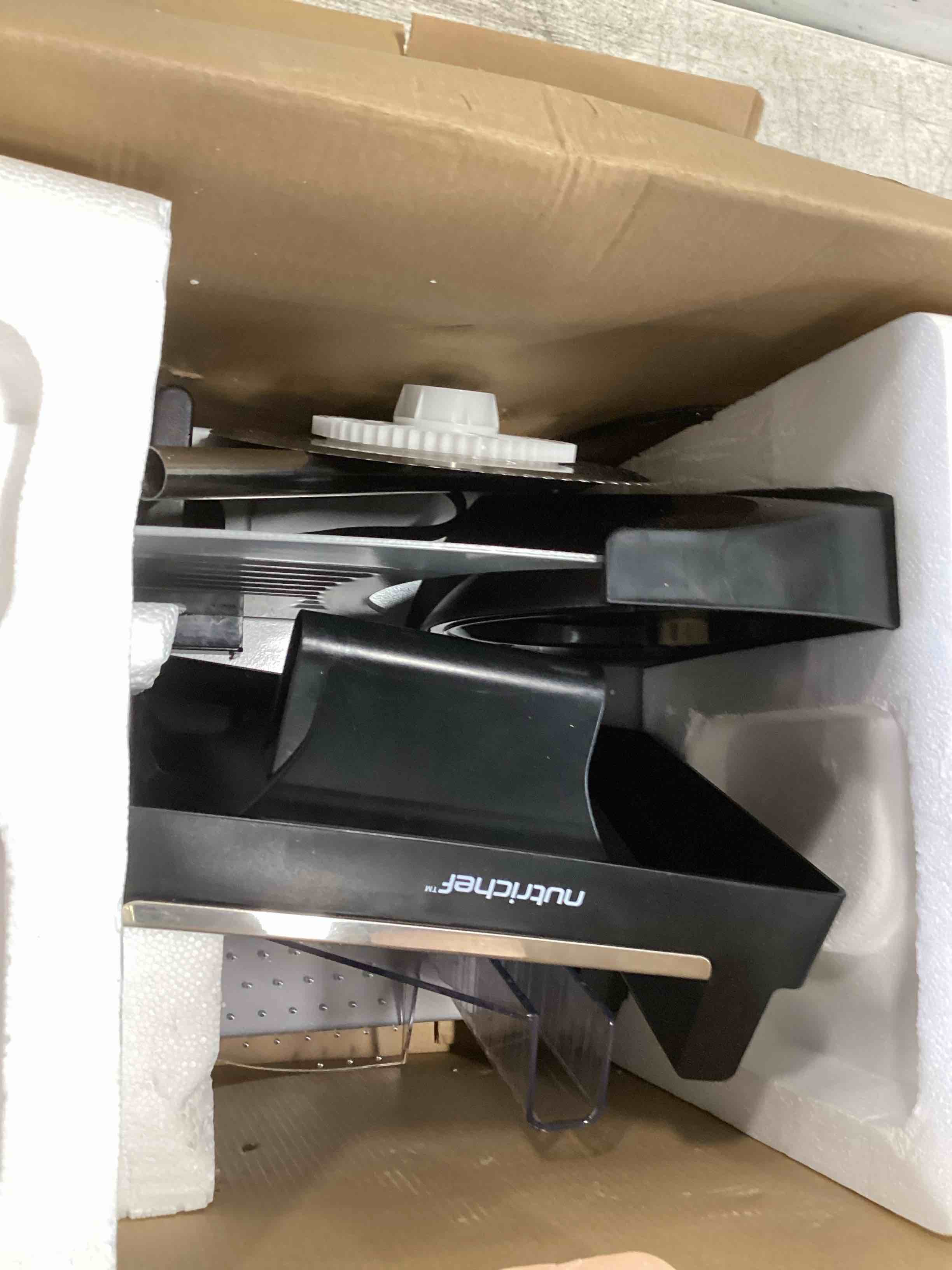 Condition photo showing As Is for nutrichef electric meat slicer | 200w automatic meat, deli & bread slicer | adjustable dial for 0-15mm cutting range thickness | removable 7.5 in stainless steel blade & food pusher for safety (black)
