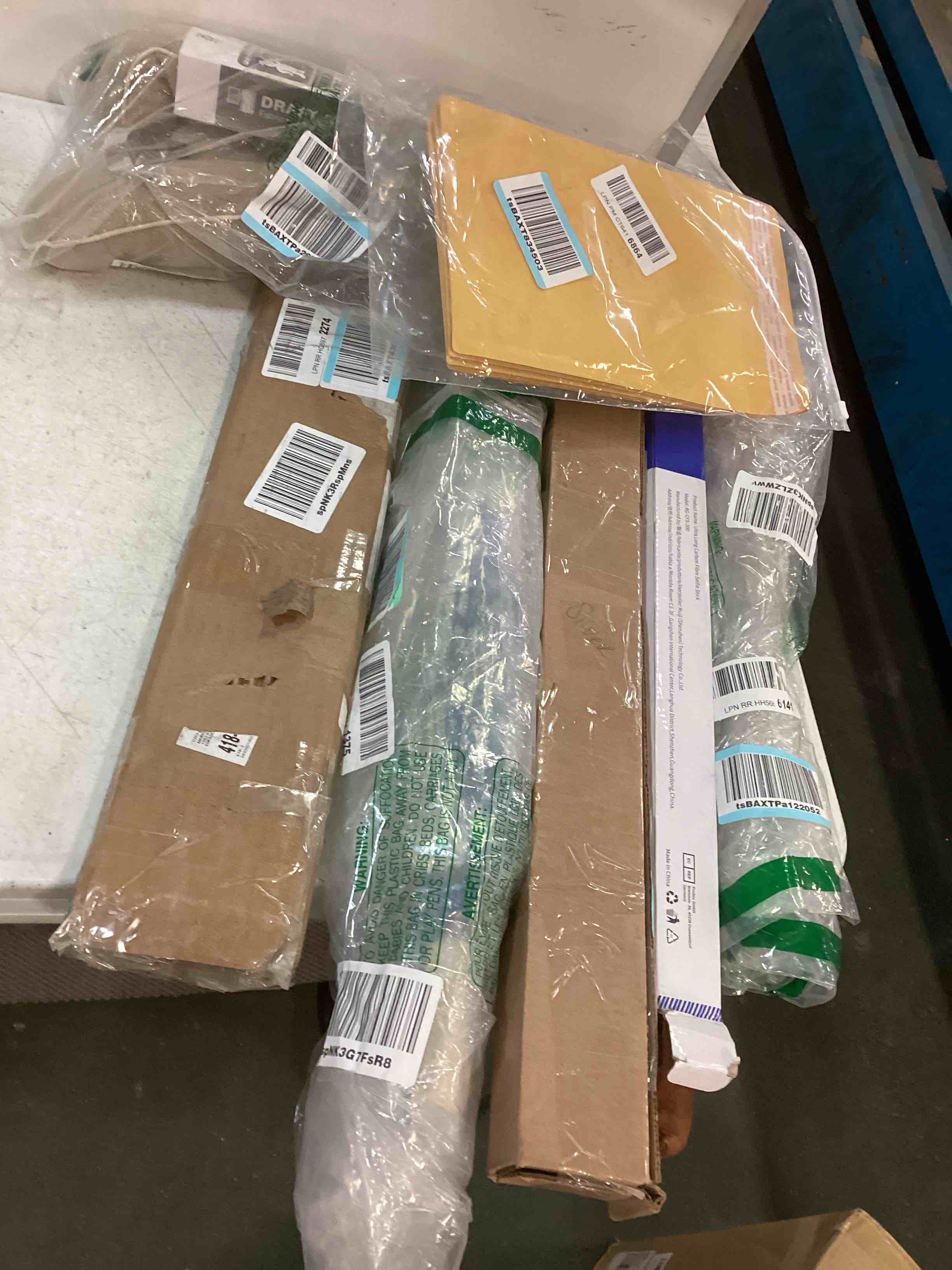 Assortment of Miscellaneous products (May Include: Selfie stick ,Yellow envelopes, and more or other use)