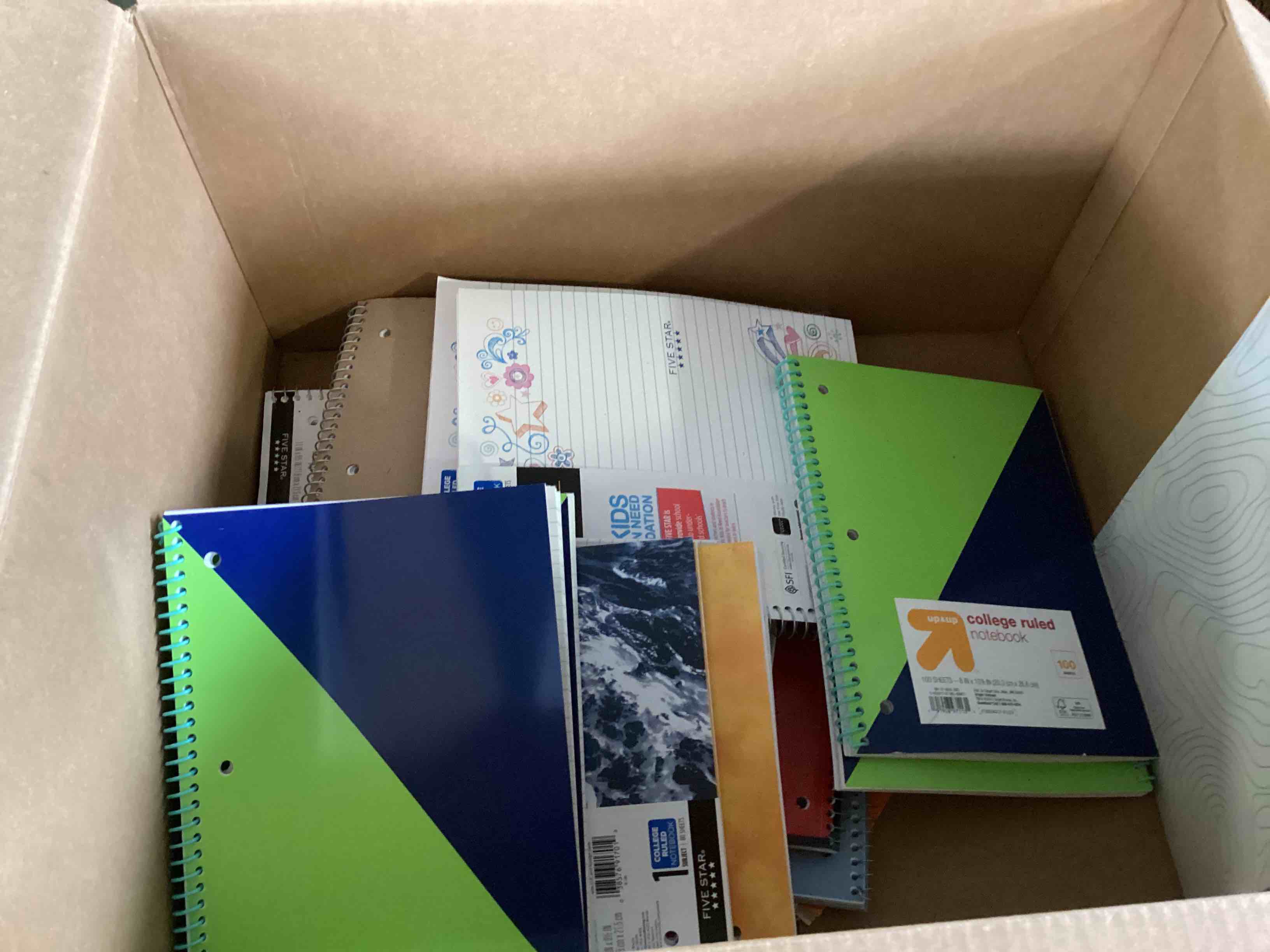 Assorted spiral notebooks and folders