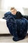 Little boy laying on a couch hugging a navy blue plush blanket.  Young woman sitting on the ground holding a navy blue plush blanket. Little boy with a navy blue plush blanket wrapped around his shoulders. Little boy snuggled up in a navy blue ruched blanket. Young woman sitting with a navy blue plush blanket held in her arms.  Hugs Navy Blanket