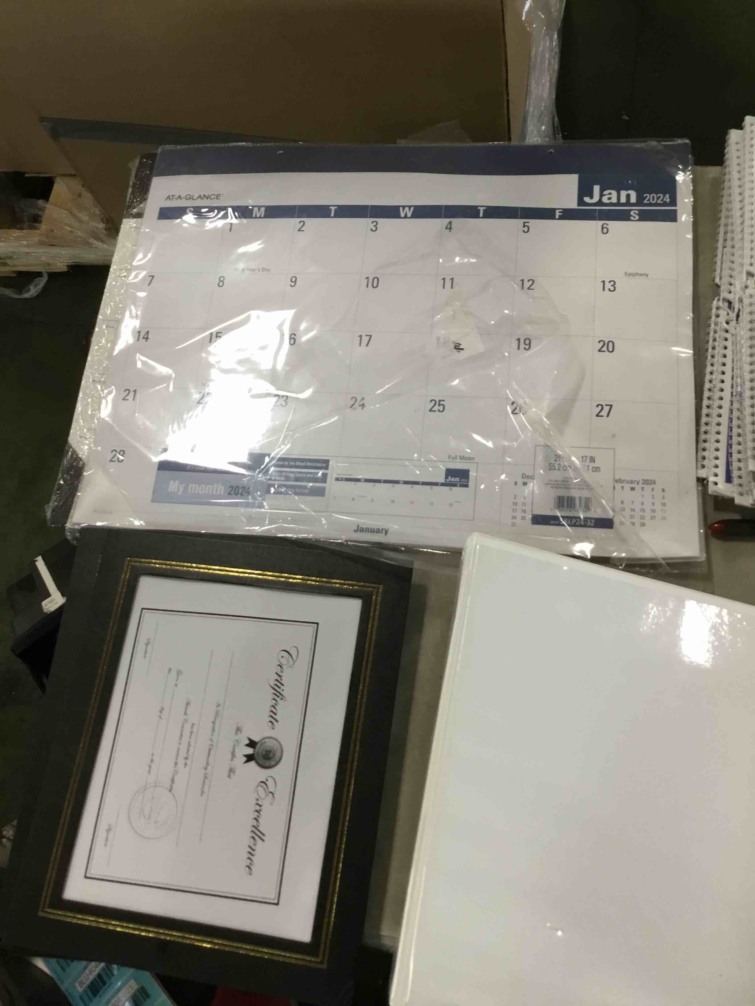 box of office supplies -calendar ,binder,stainless steel cleaner and more 