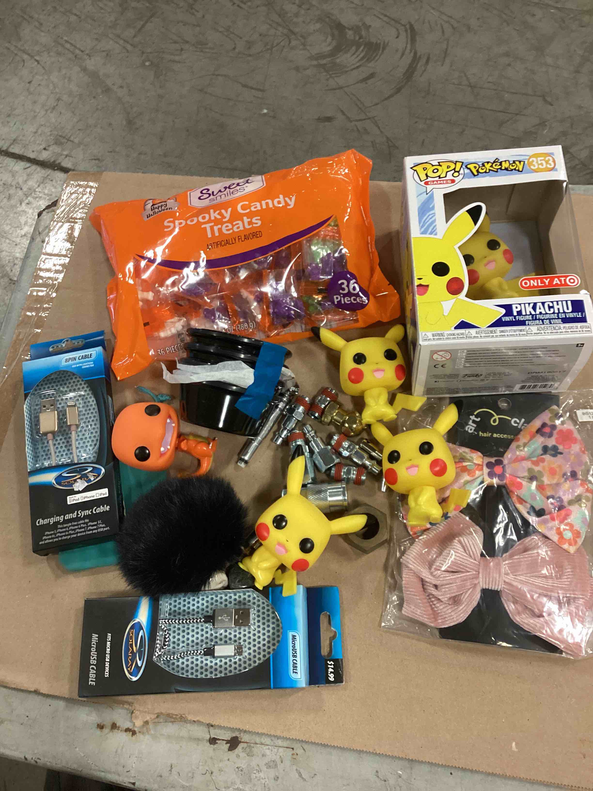 ASSORTMENT OF THIS & THAT: CHARGING AND SYNC CABLES, PIKACHU POP!, HAIR DECORATIONS, CANDY TREATS AND MORE