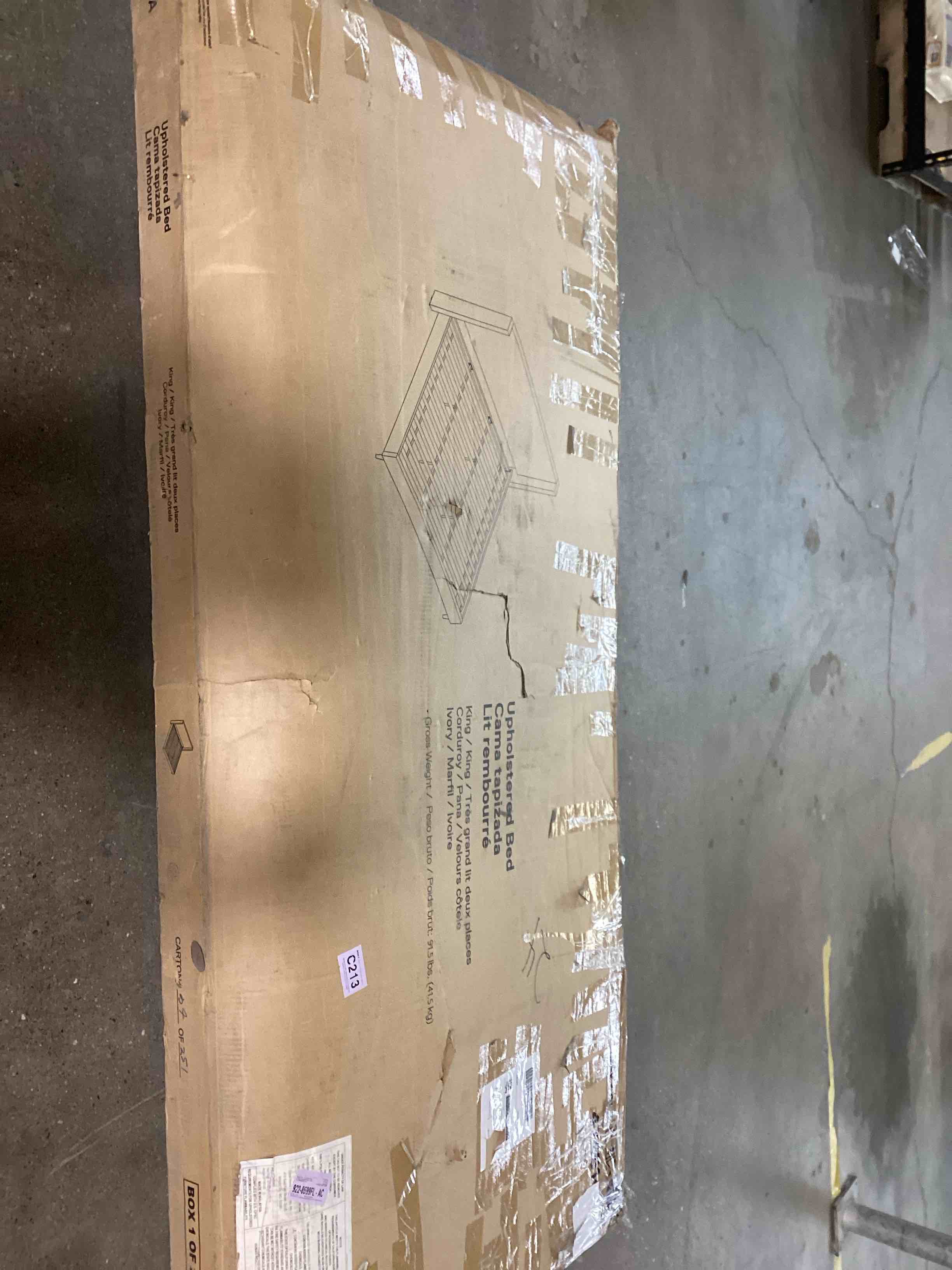 Condition photo showing As Is for upholstered bed. incomplete only box 1 out of 2.