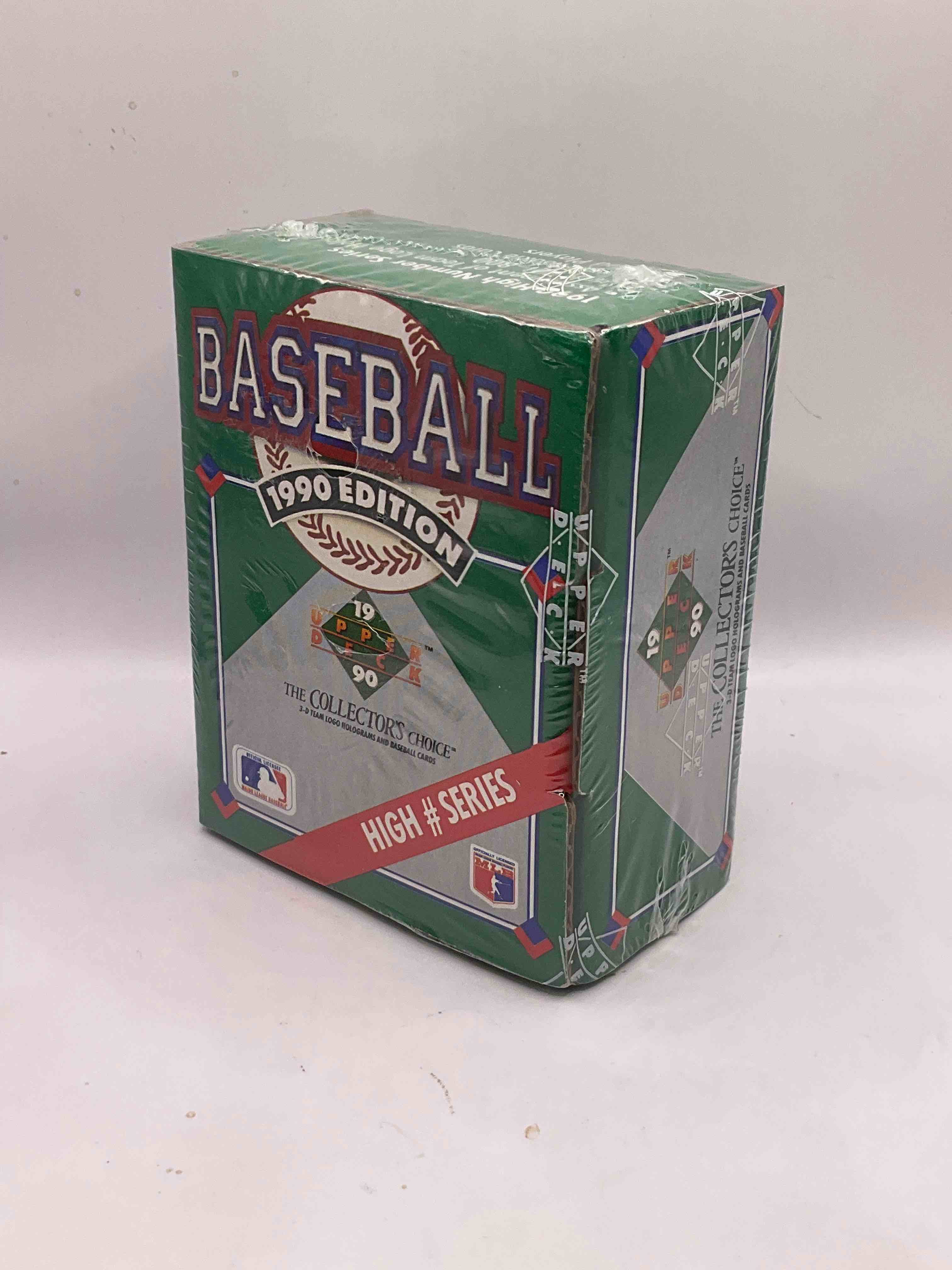 1990 High Series! First Ever Auto Insert, Possibility! 1990 Upper Deck Baseball HIGH SERIES Sealed Box! Box Includes Cards 701-800 & Contains The Newest Rookies & Traded Players From 1990. This Box Has Become Infamous For "Find The Reggie!" There Were 2500 Randomly Inserted Signed Reggie Jackson Hero Cards Placed In These Boxes, The First Time Random Auto Cards Were Packed In Hobby Boxes (A Common Practice Today). Search For The Possibility Of A Reggie Signed Auto Card (PSA 10 Value $750. A Great Piece Of Sports Memorabilia!