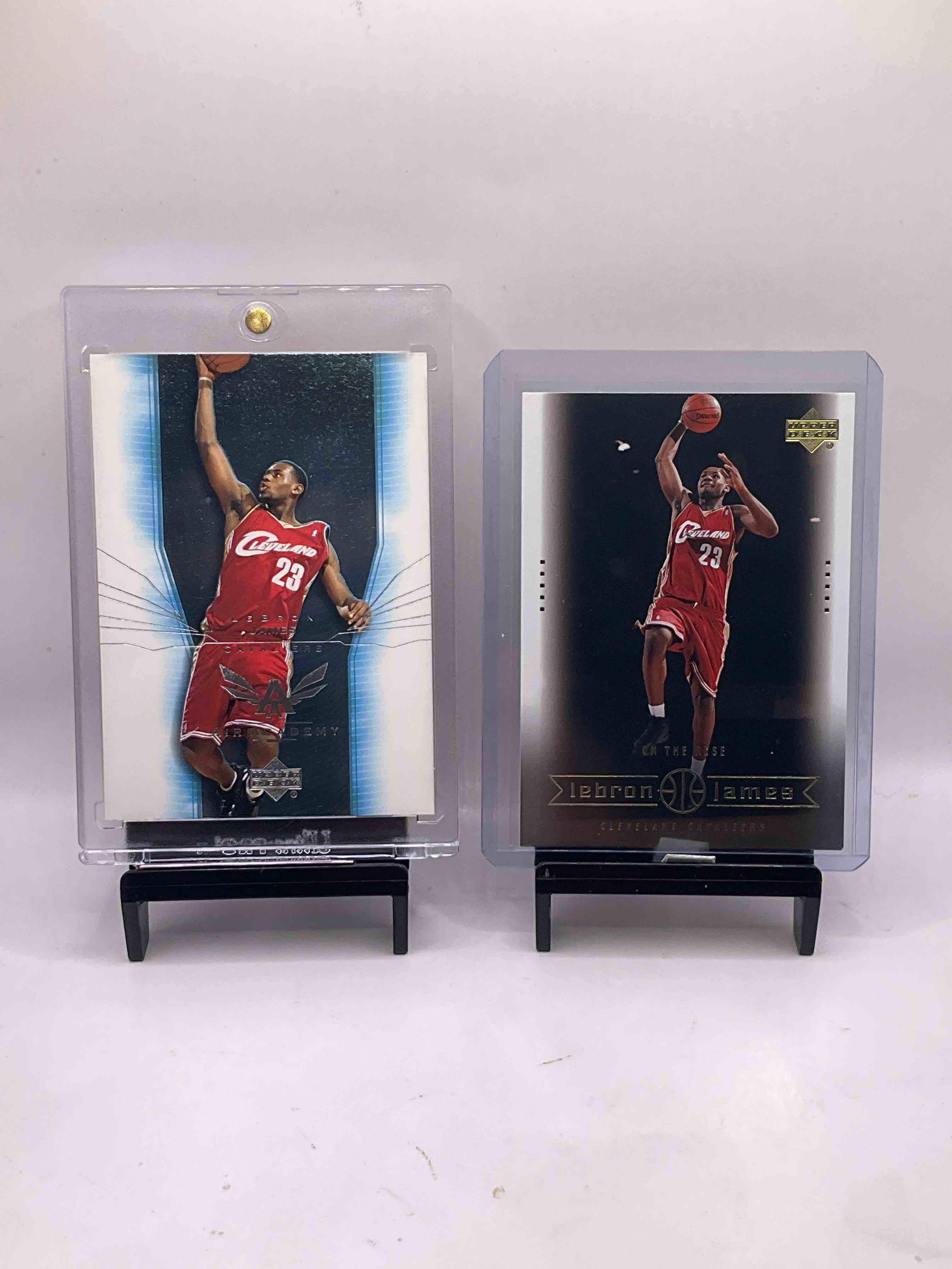 Lebron James ROOKIES! Two 2003 Lebron James Upper Deck Rookie Cards, "Air Academy" & "On The Rise." Both Cards In Excellent Condition & In Sleeves And Protective Holders. A Rare Opportunity to Acquire Two Lebron James Rookie Cards That Are Nearly Impossible To Get Ahold Of! An Incredible Sports Card Memorabilia Investment!