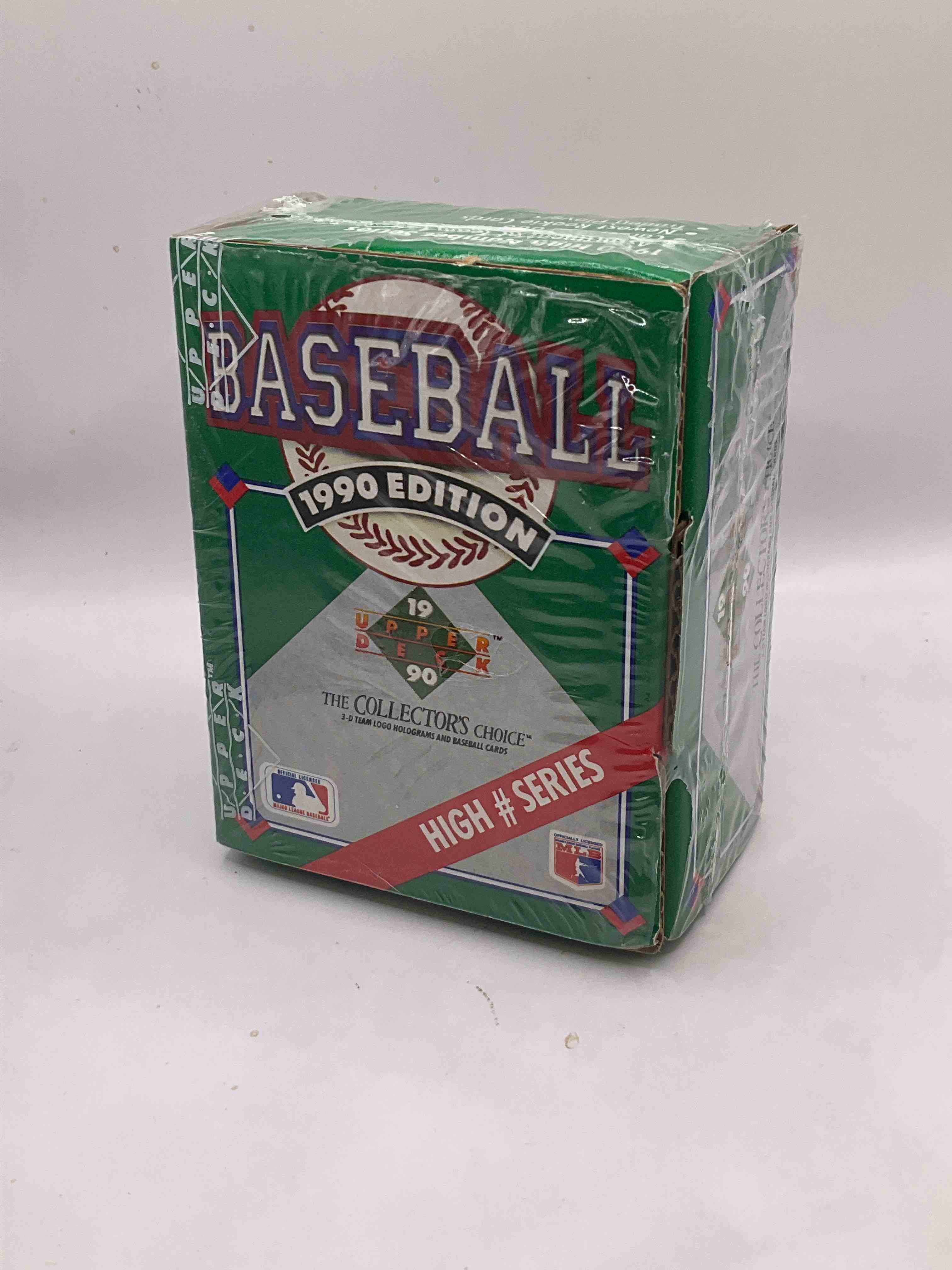 1990 High Series! First Ever Auto Insert, Possibility! 1990 Upper Deck Baseball HIGH SERIES Sealed Box! Box Includes Cards 701-800 & Contains The Newest Rookies & Traded Players From 1990. This Box Has Become Infamous For "Find The Reggie!" There Were 2500 Randomly Inserted Signed Reggie Jackson Hero Cards Placed In These Boxes, The First Time Random Auto Cards Were Packed In Hobby Boxes (A Common Practice Today). Search For The Possibility Of A Reggie Signed Auto Card (PSA 10 Value $750. A Great Piece Of Sports Memorabilia!