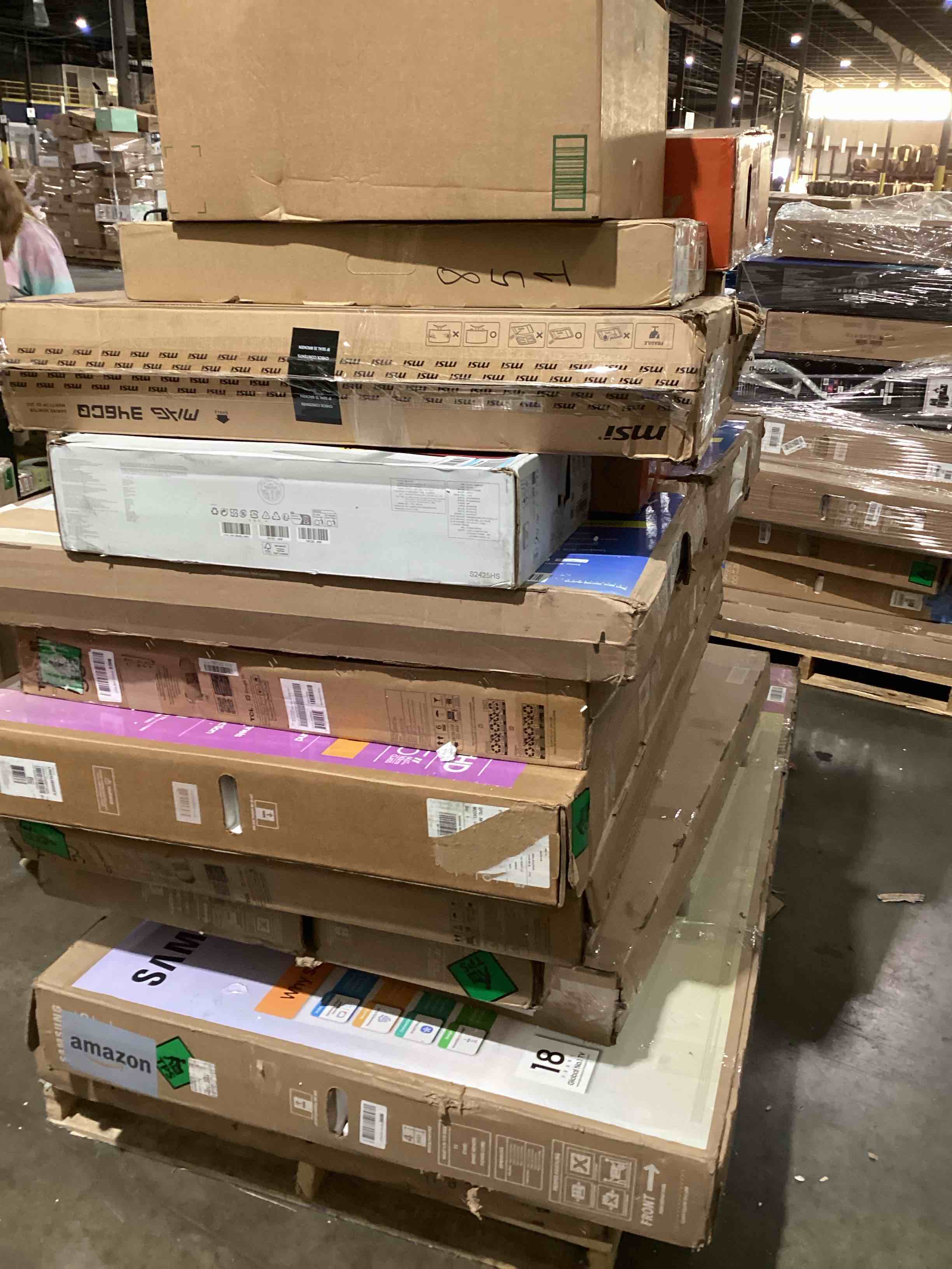 pallet of broken TVs and monitors 