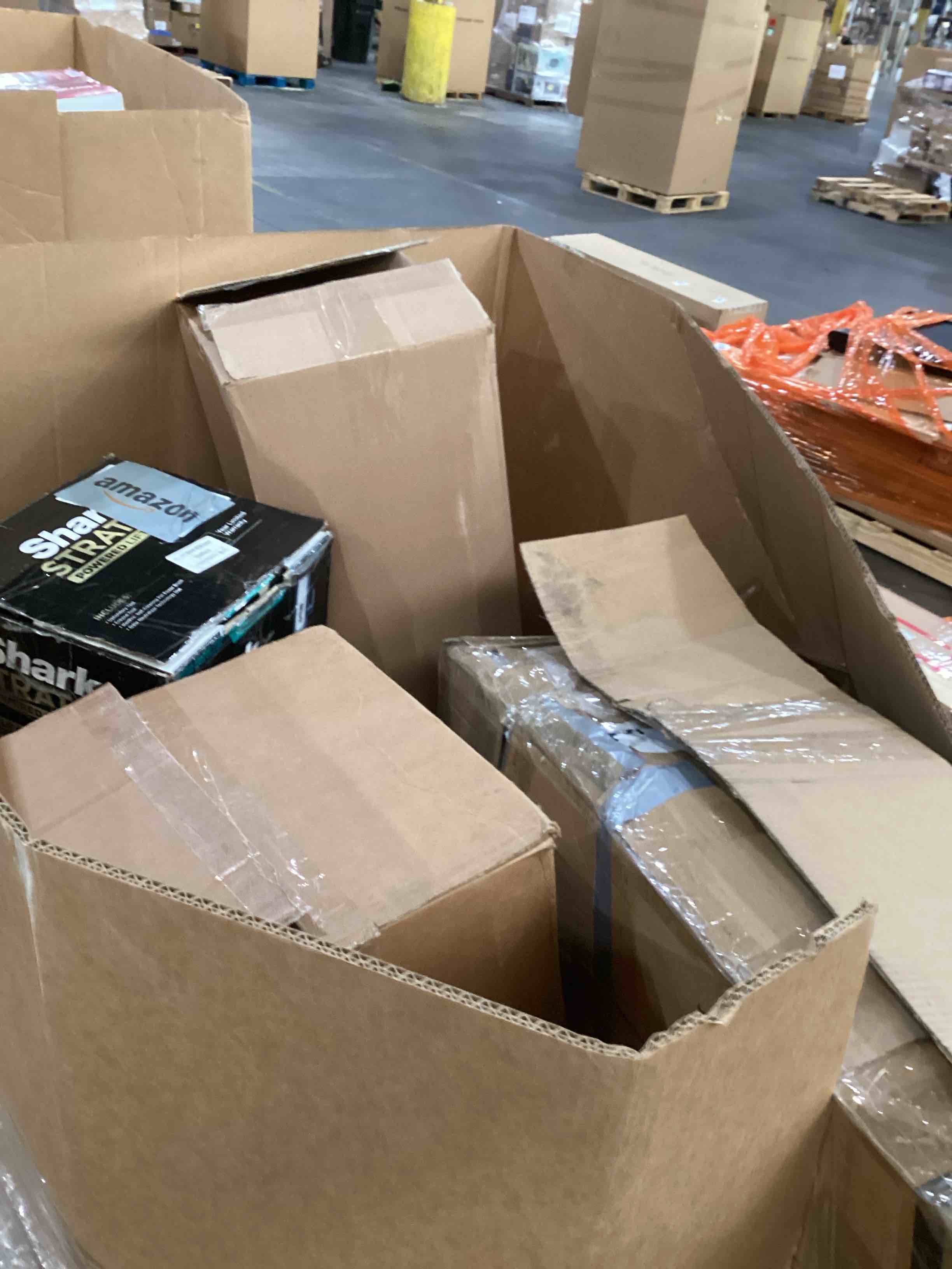 Condition photo showing As Is for pallet of damaged miscellaneous appliances and parts