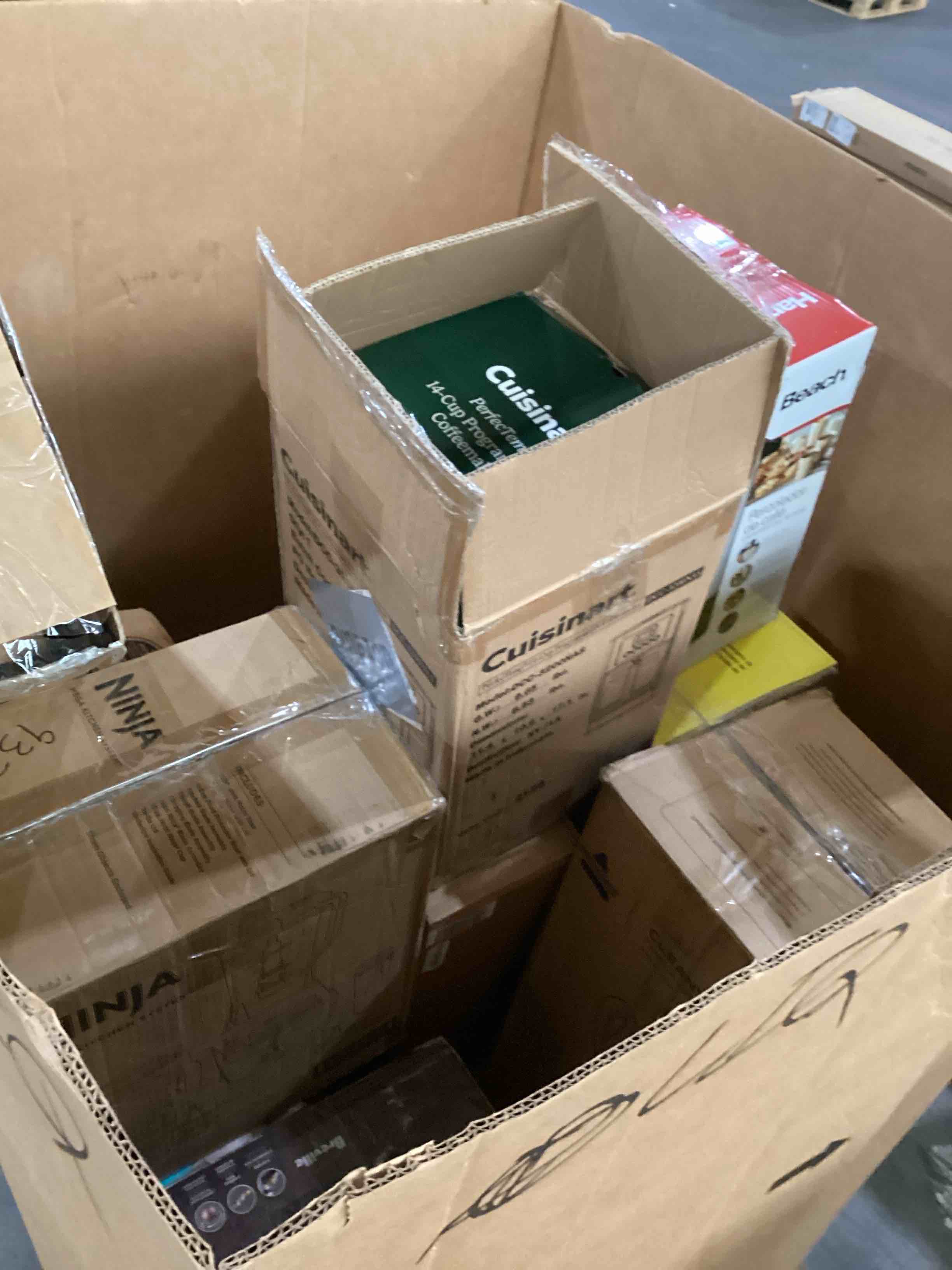 Condition photo showing As Is for pallet of damaged miscellaneous appliances and parts