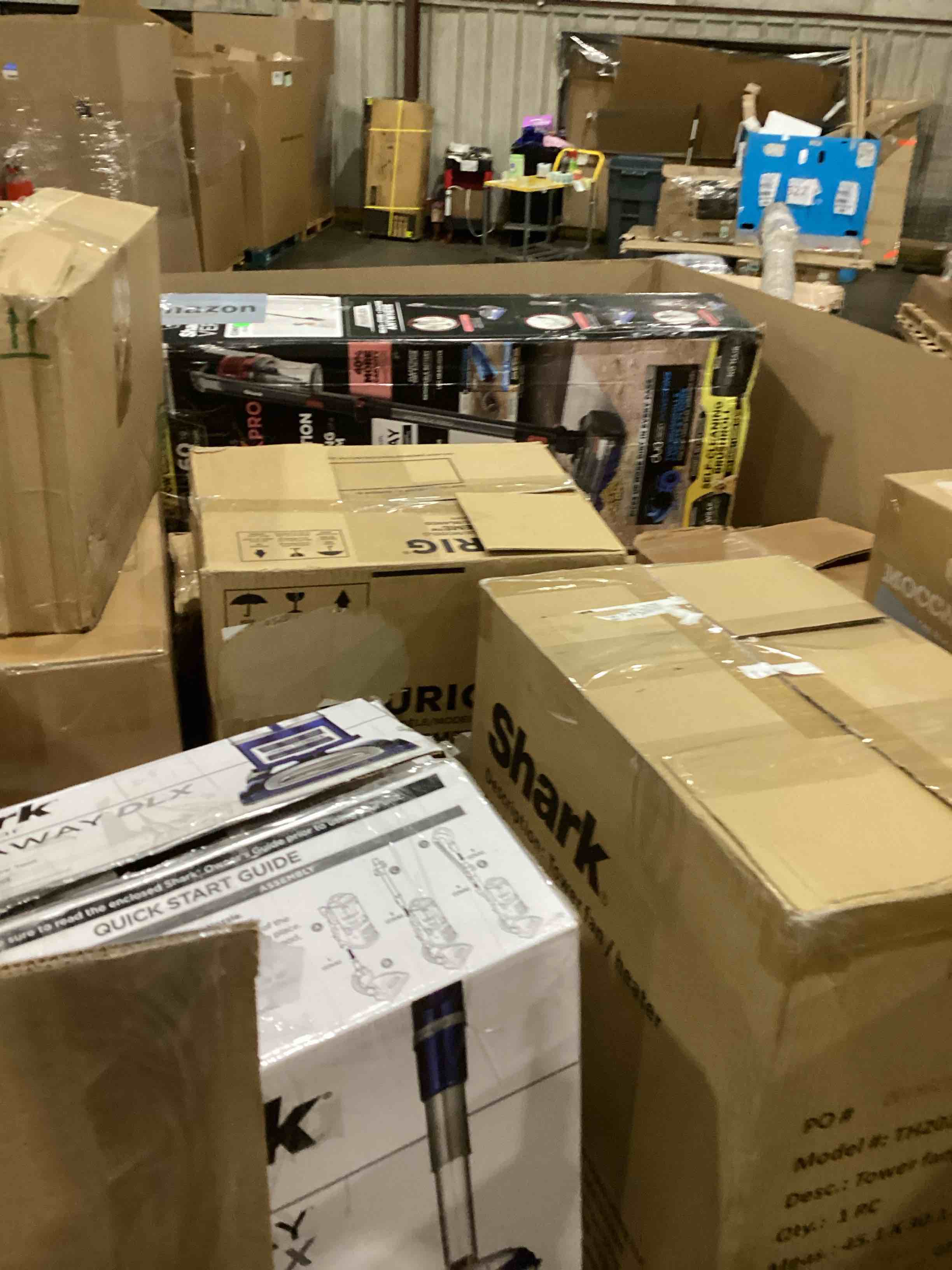 Condition photo showing As Is for pallet of damaged miscellaneous appliances and parts