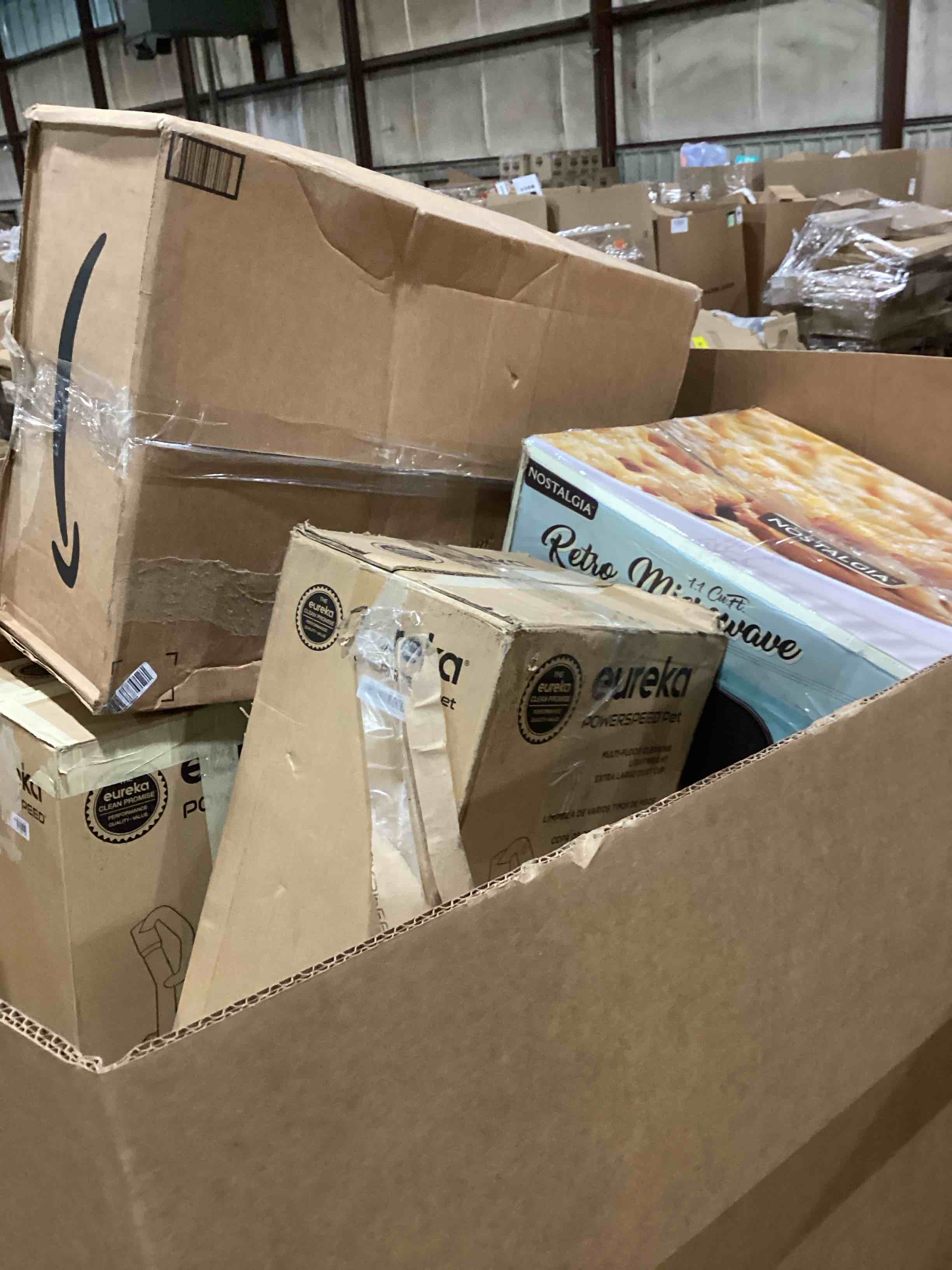 Condition photo showing As Is for pallet of damaged miscellaneous appliances and parts