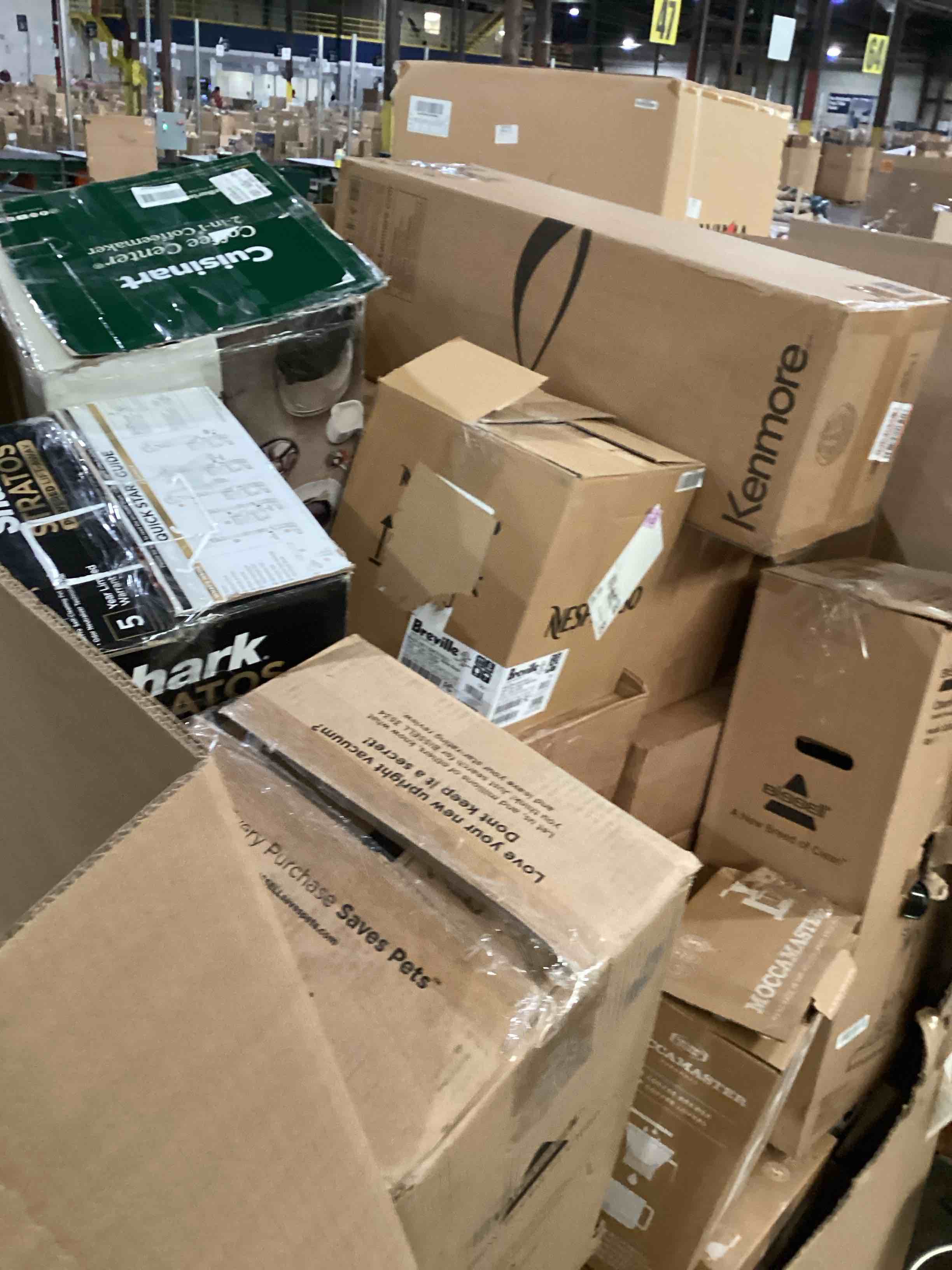 Condition photo showing As Is for pallet of damaged miscellaneous appliances and parts 