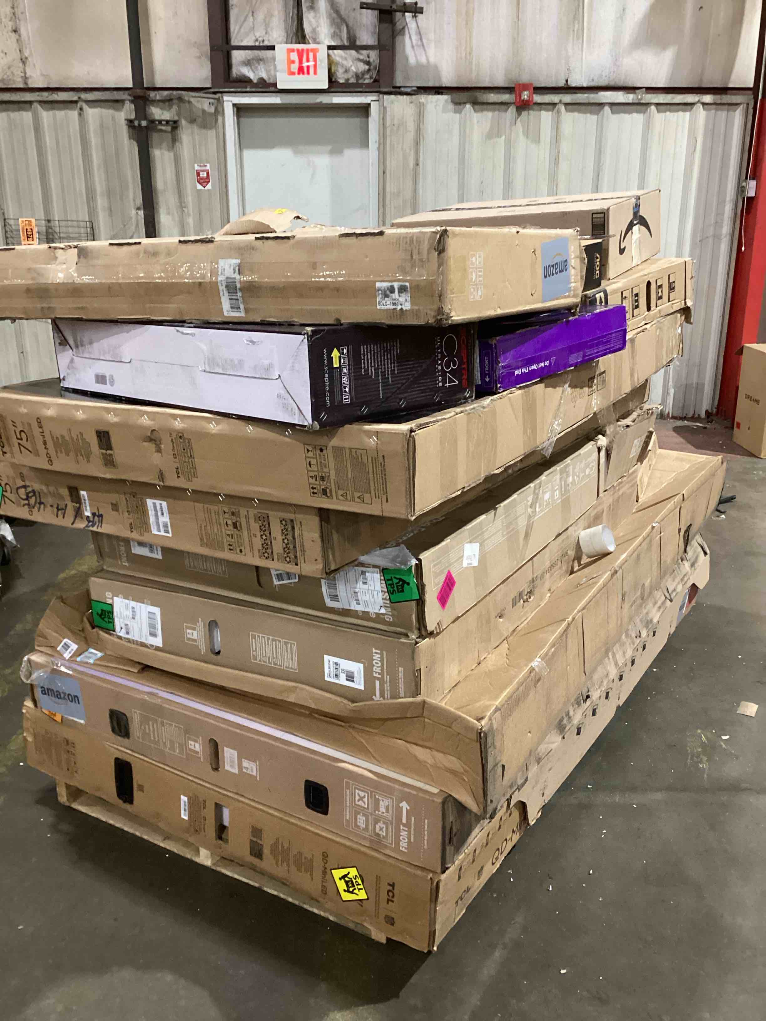 pallet of broken tvs and monitors 