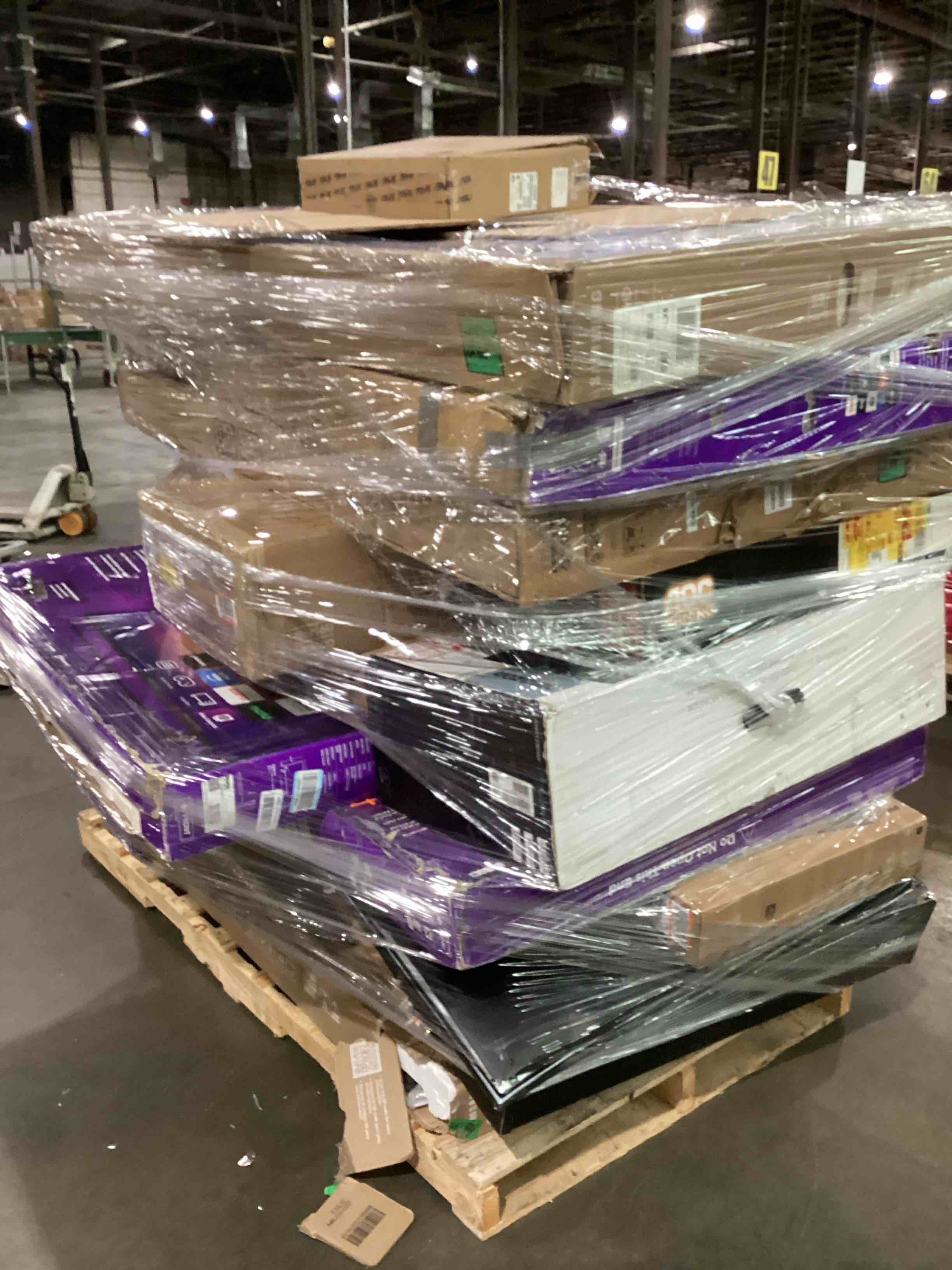 pallet of broken tvs and monitors 