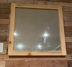 framed mirror with visible hinges