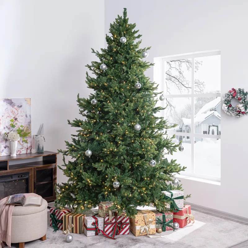 traditional prelit artificial Christmas tree with warm lights and metal