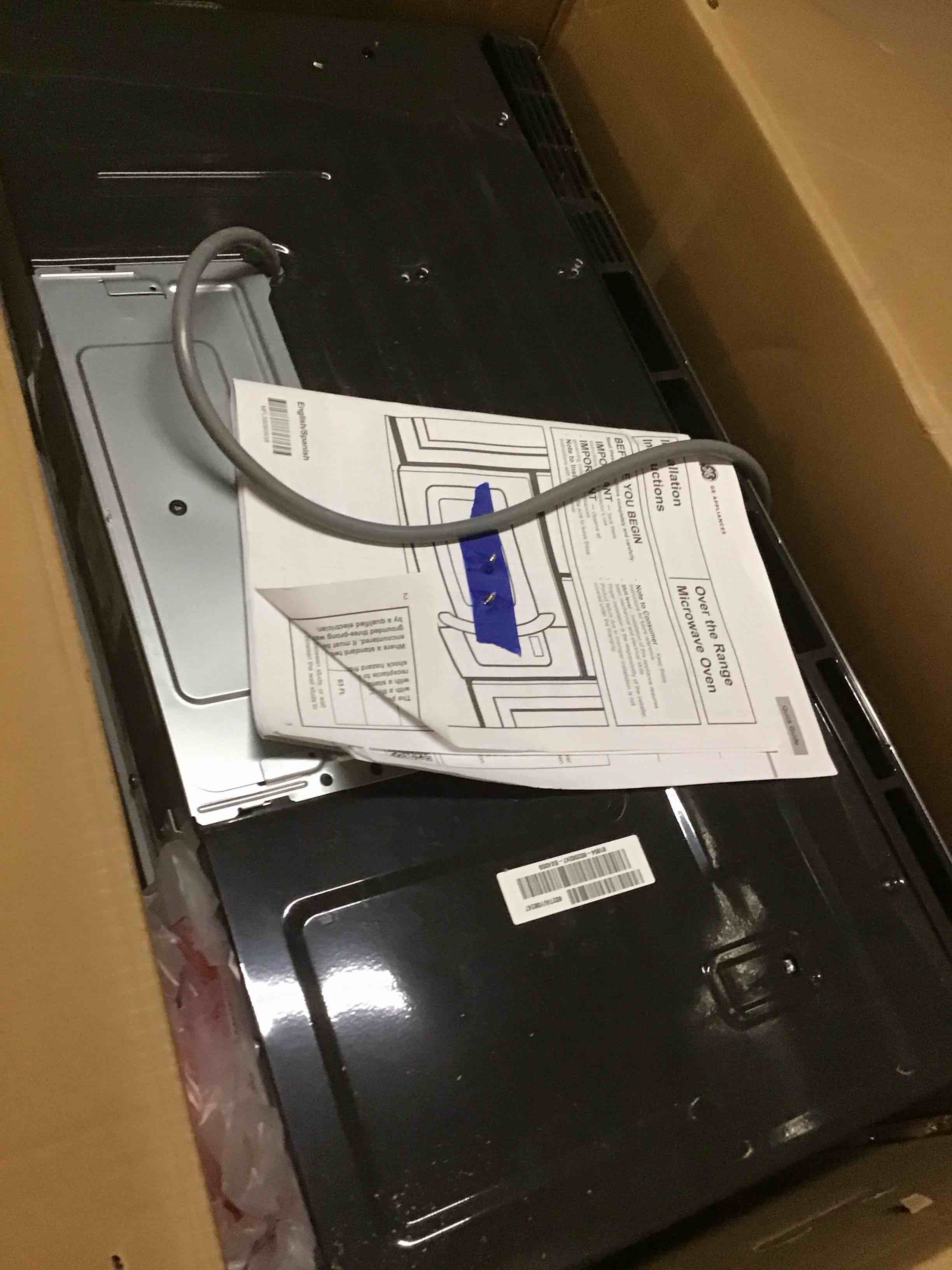 Condition photo showing As Is for ( with bent) 30 in. over-the-range microwave in stainless steel with dishwasher safe grease filter and vent