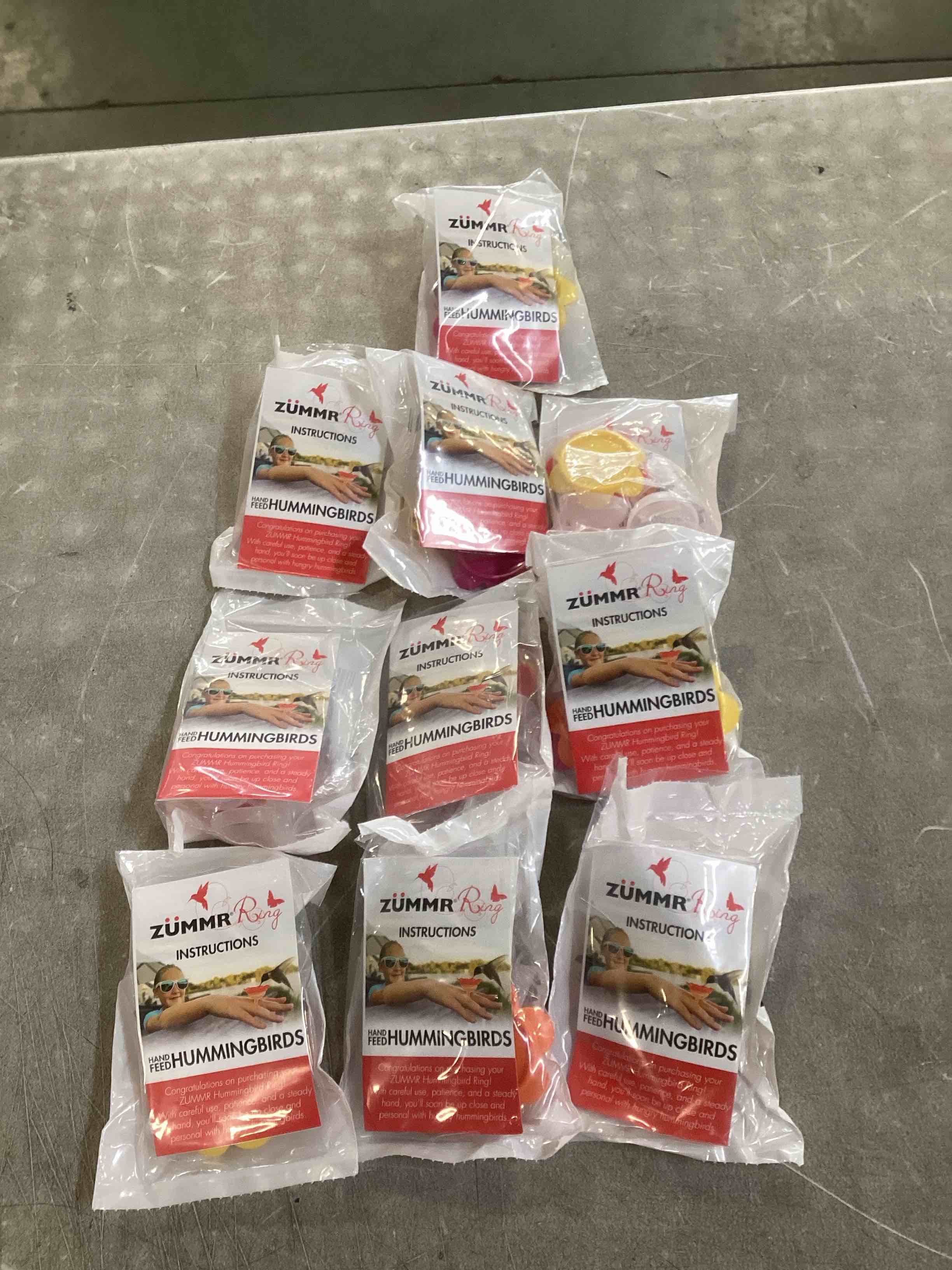 Condition photo showing New/Like New for (3-Pack) - ZUMMR Hummingbird Ring Feeder (Red  Green and Blue) 10 count 