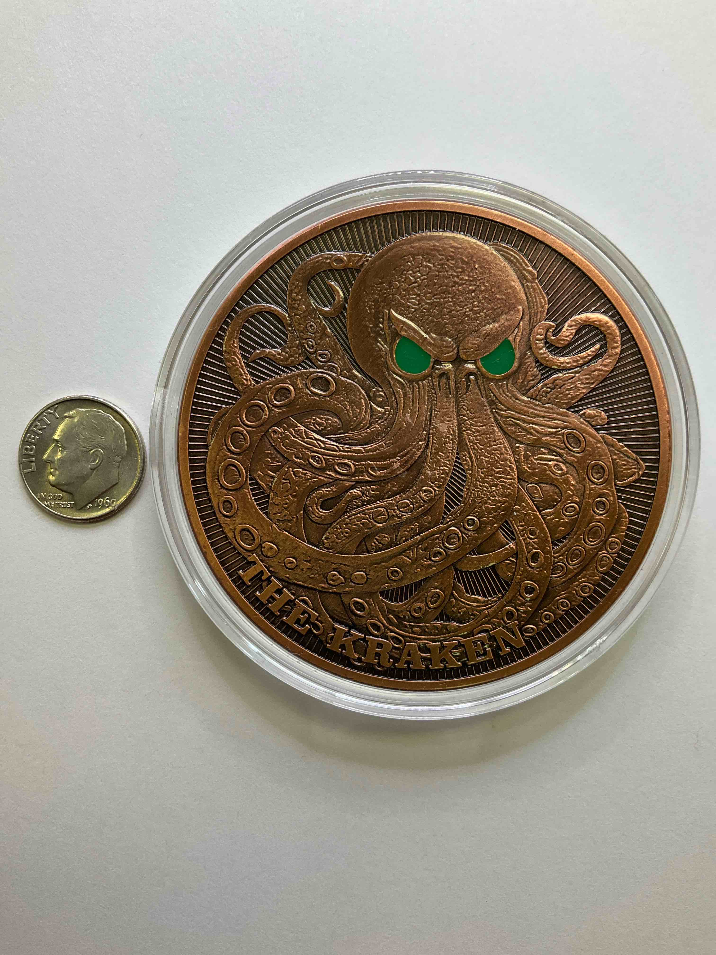 Huge Pure Copper Kraken Wow! Giant 5 oz Pure Fine U.S. Copper Collector Coin! Almost 3" Diameter! Check Out This Massive 5 OZ Pure Copper Coin, With The Image Of The Legendary Kraken With Colored Eyes! Makes For A Great Gift & Cool Investment In Copper. Copper Value Continues To Rise & Copper Also Has Amazing Health Benefits. Rare To See Pure Copper In Such A Large Size! U.S. Dime Shown In Image Is For Size Reference Only (not included). Comes In Clear Holding Case. Invest In Fine U.S. Copper!