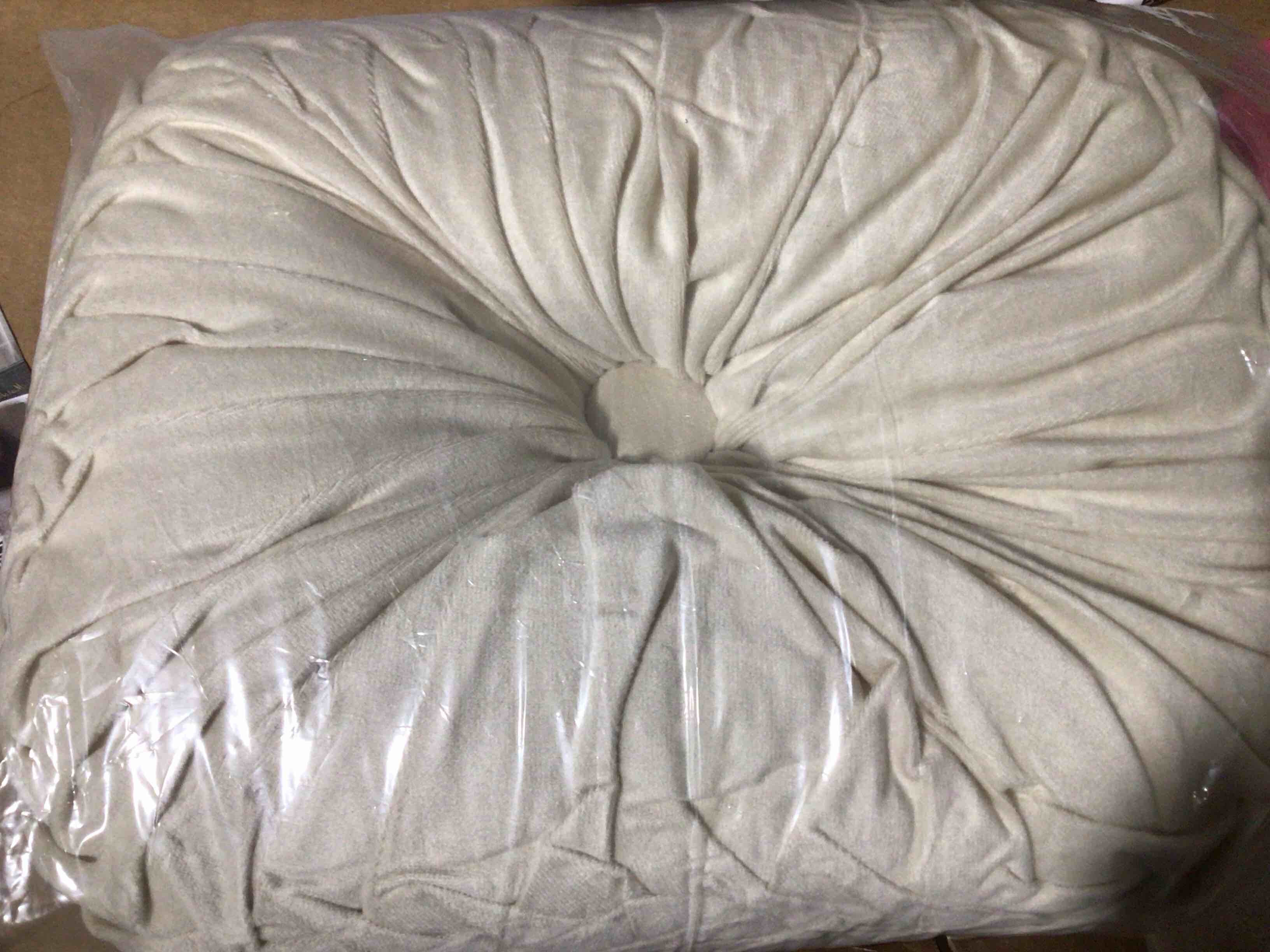Condition photo showing New/Like New for round shaped wrinkled pillow, beige