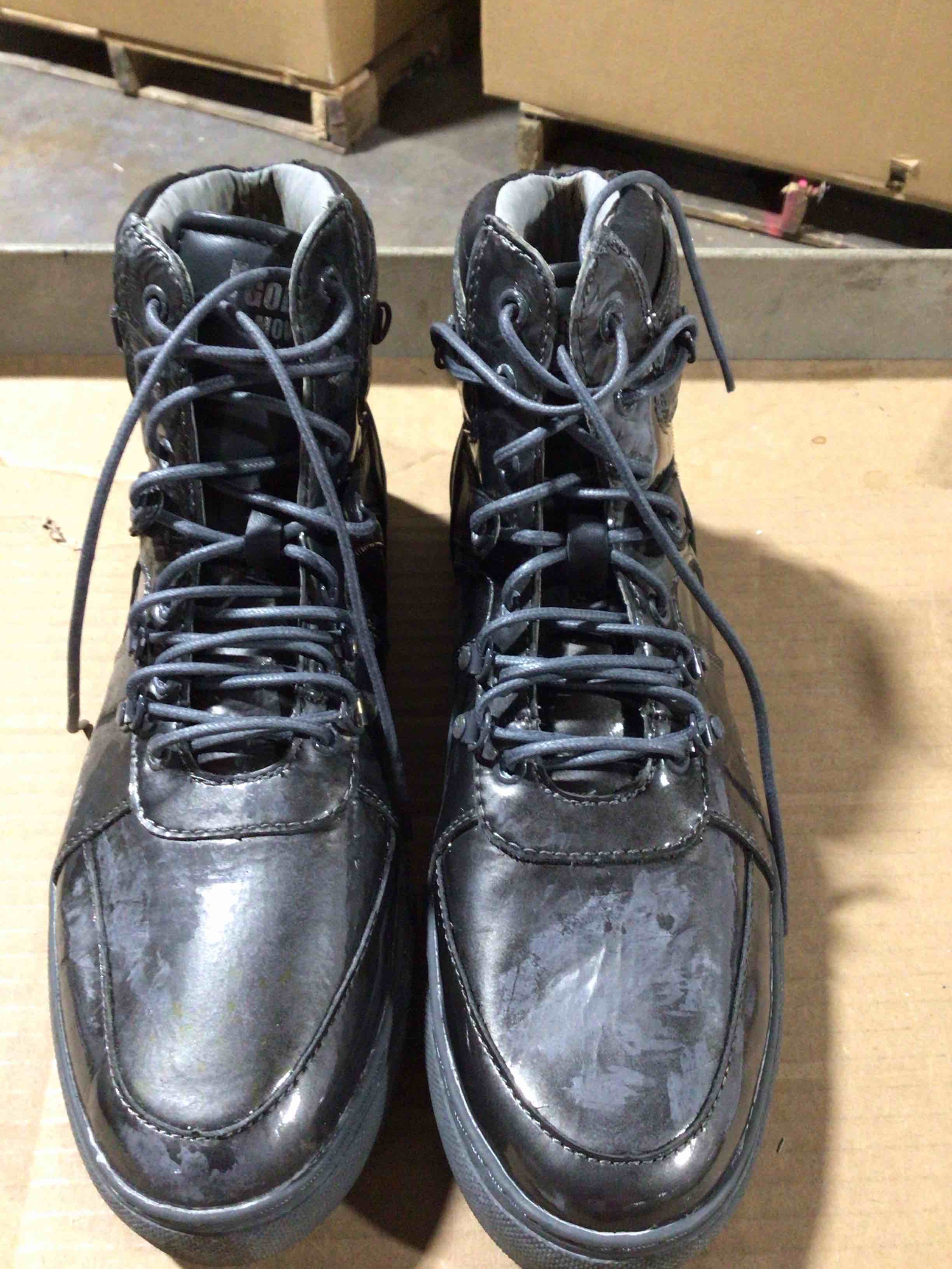 High - top casual boots, probably for men, with a sports shoe design.they are made of a black leather or synthetic leather material 