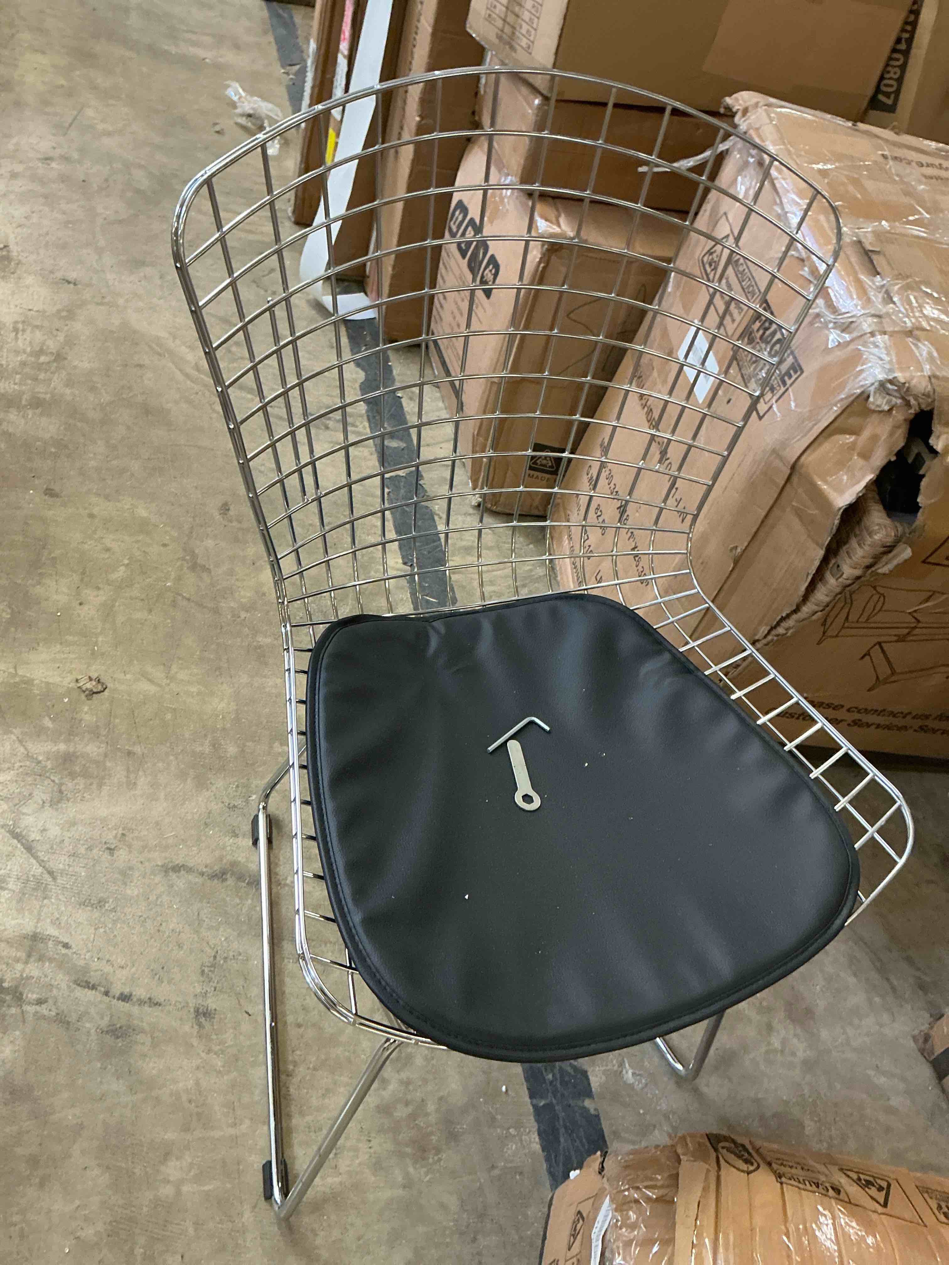 Condition photo showing Good Condition for mlf harry bertoia wire side chair chromed wire frame with plastic feet & pu leather cushion. (black) ( missing one leg tip cap)