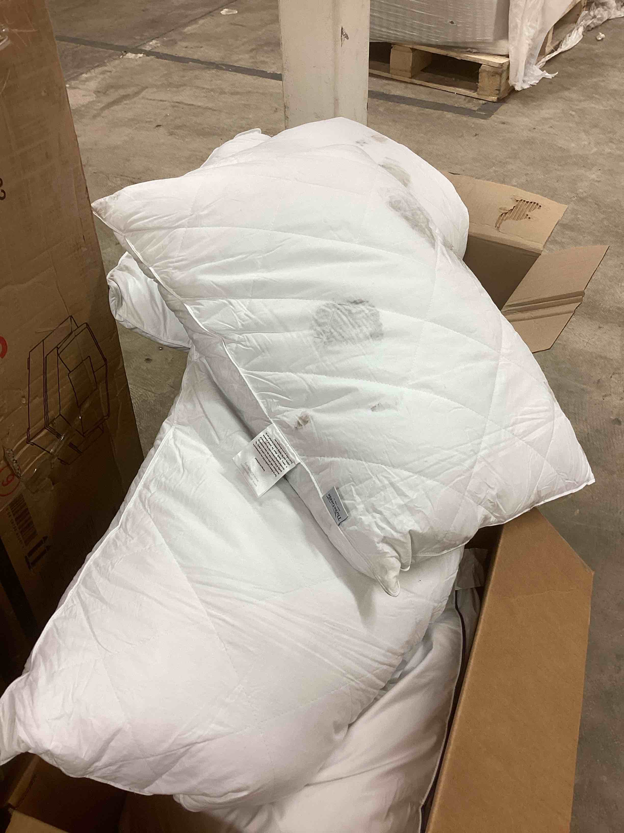 Condition photo showing As Is for assorted bedding items (comforter and pillows)