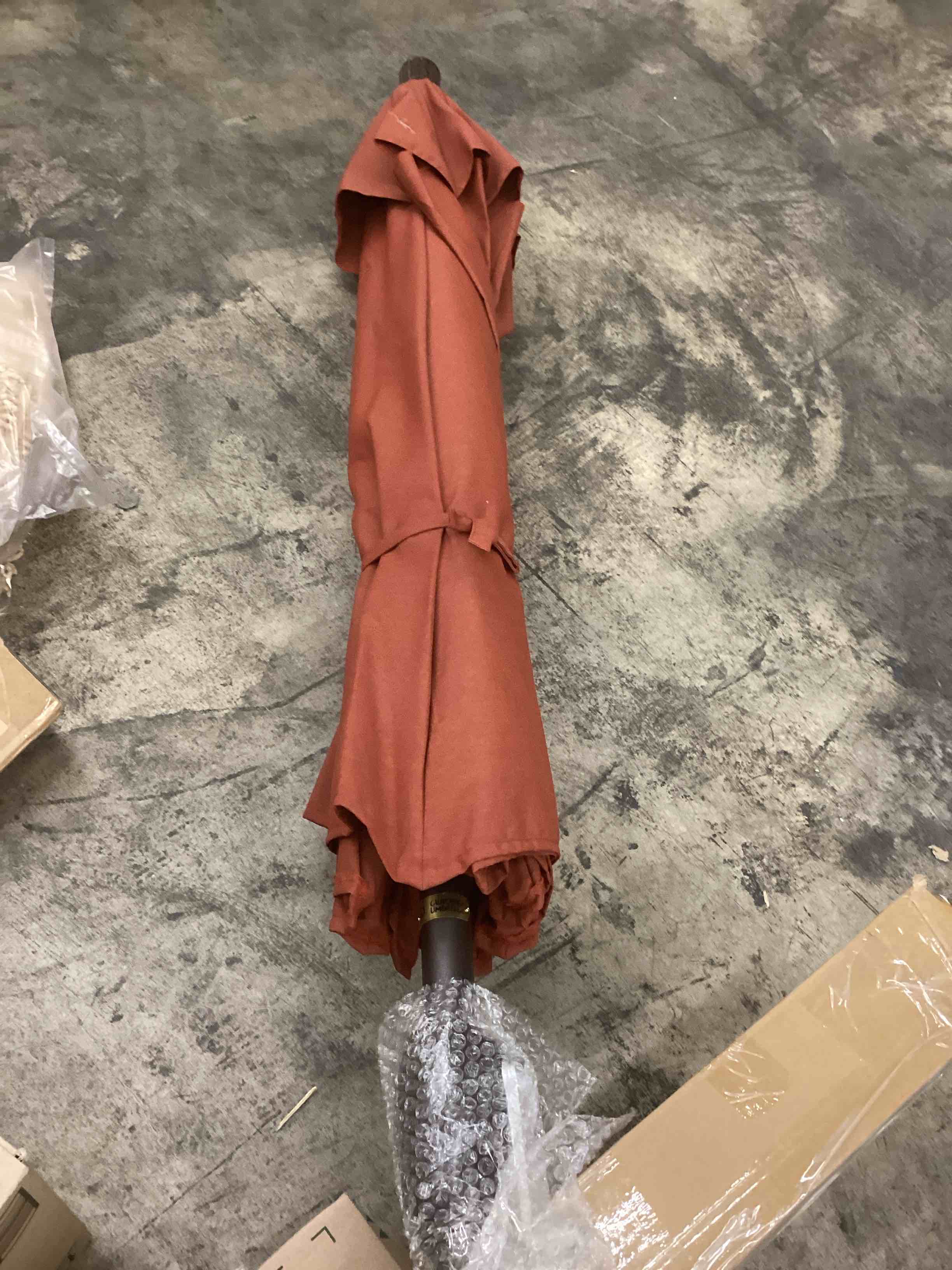 Condition photo showing As Is for 7.5’ outdoor umbrella terracotta 