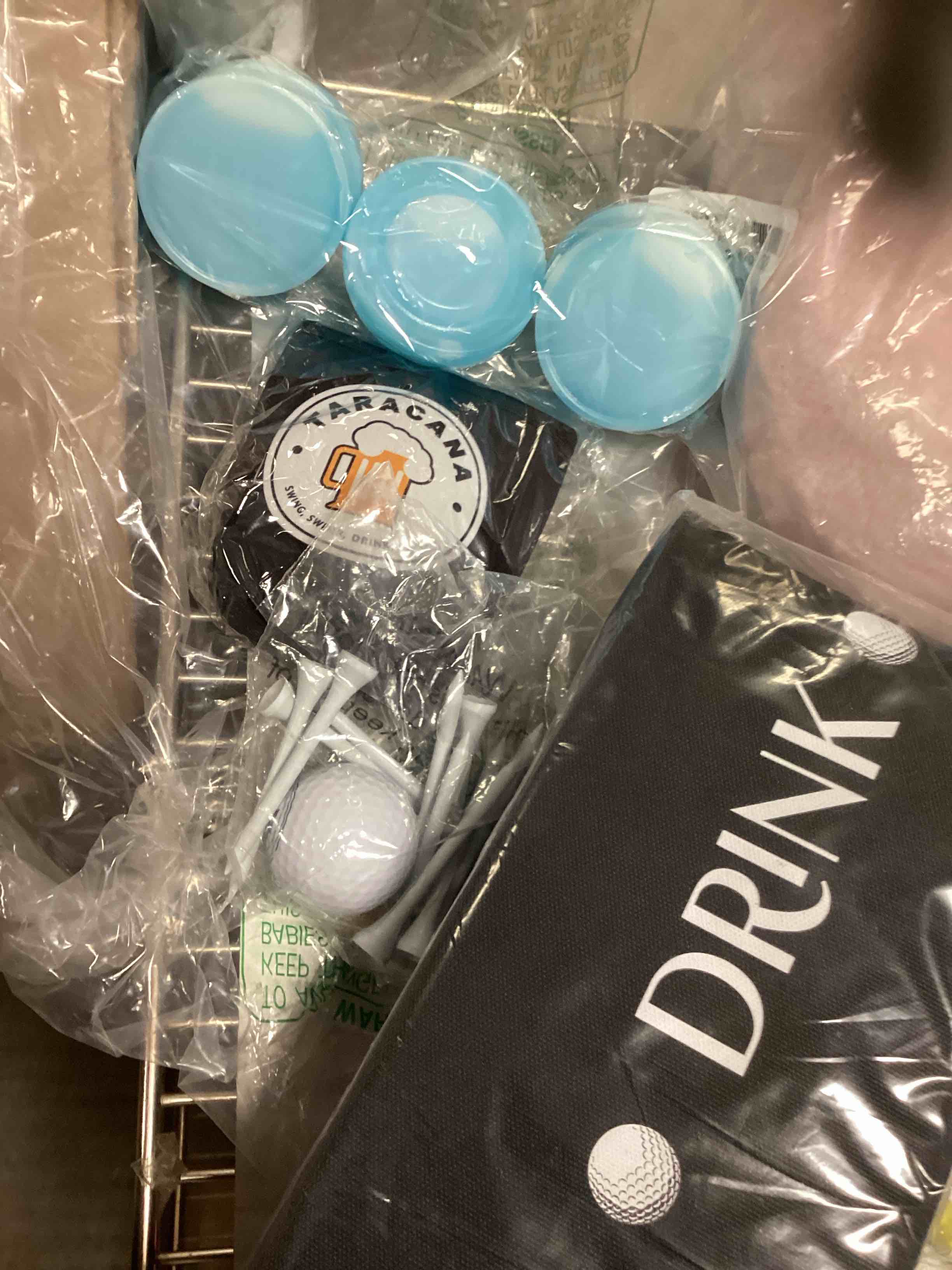 Tracana Swing Swear Drink Repeat Golf Balls: El Kit contains golf ball, often used for putting practice.