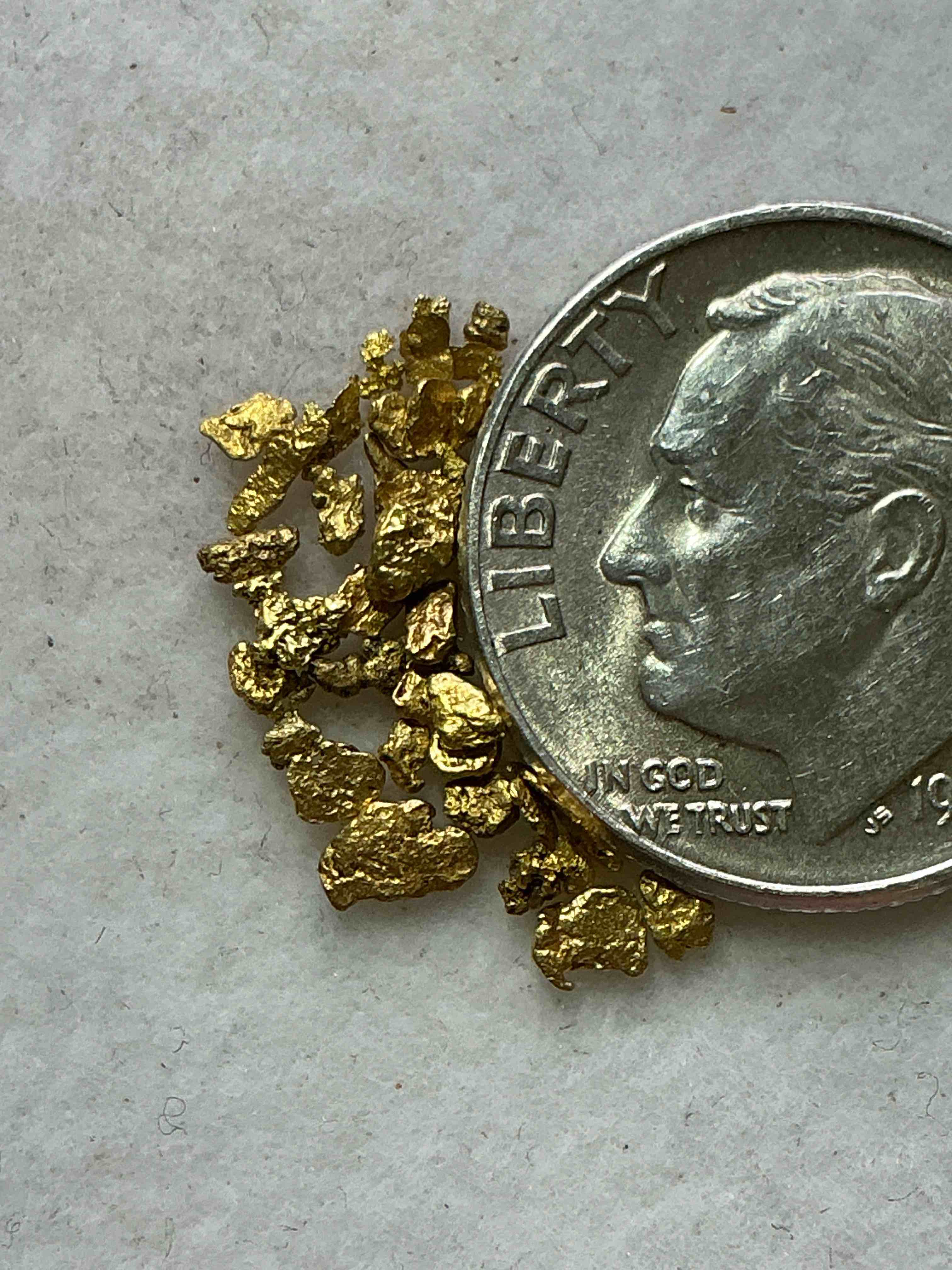 Condition photo showing New/Like New for Genuine Gold Nuggets! Gold Nuggets Fresh From Prospecting North Carolina Mountains, Total Weight Of All Nuggets Is Approximately .5 Grams. These Gold Nuggets Typically Test At Between Approx 22-24 Karat. Gold In Raw, Prospected Form Is Extremely Hard To Find & Much Rarer Than Any Refined Form. Get In On The Gold Craze... Gold Has Increased In Value Over 40% Since 2025! U.S. Dime For Size Reference Only (not included). Gold Vile In Image Included. Own Genuine, Gold Nuggets!