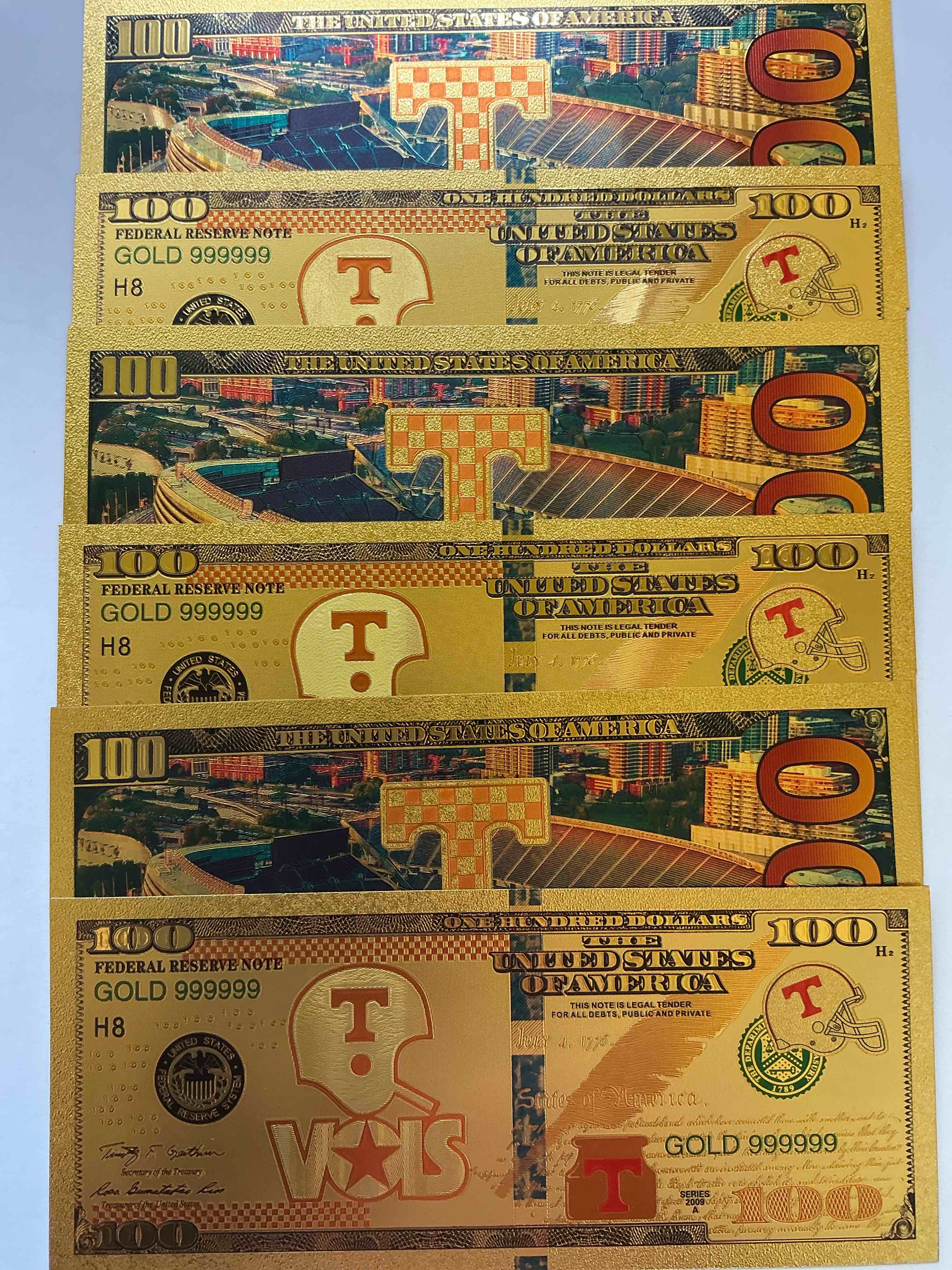 Condition photo showing New/Like New for TENNESSEE VOLUNTEERS Collectible Memorabilia! Super Cool, Gold In Color 100 Dollar Commemorative Ohio State University Bill! Cool Designs On Front & Back Of Bill! UT Fans Rejoice, Cool Memorabilia! Plastic Bills With Cool Designs! 