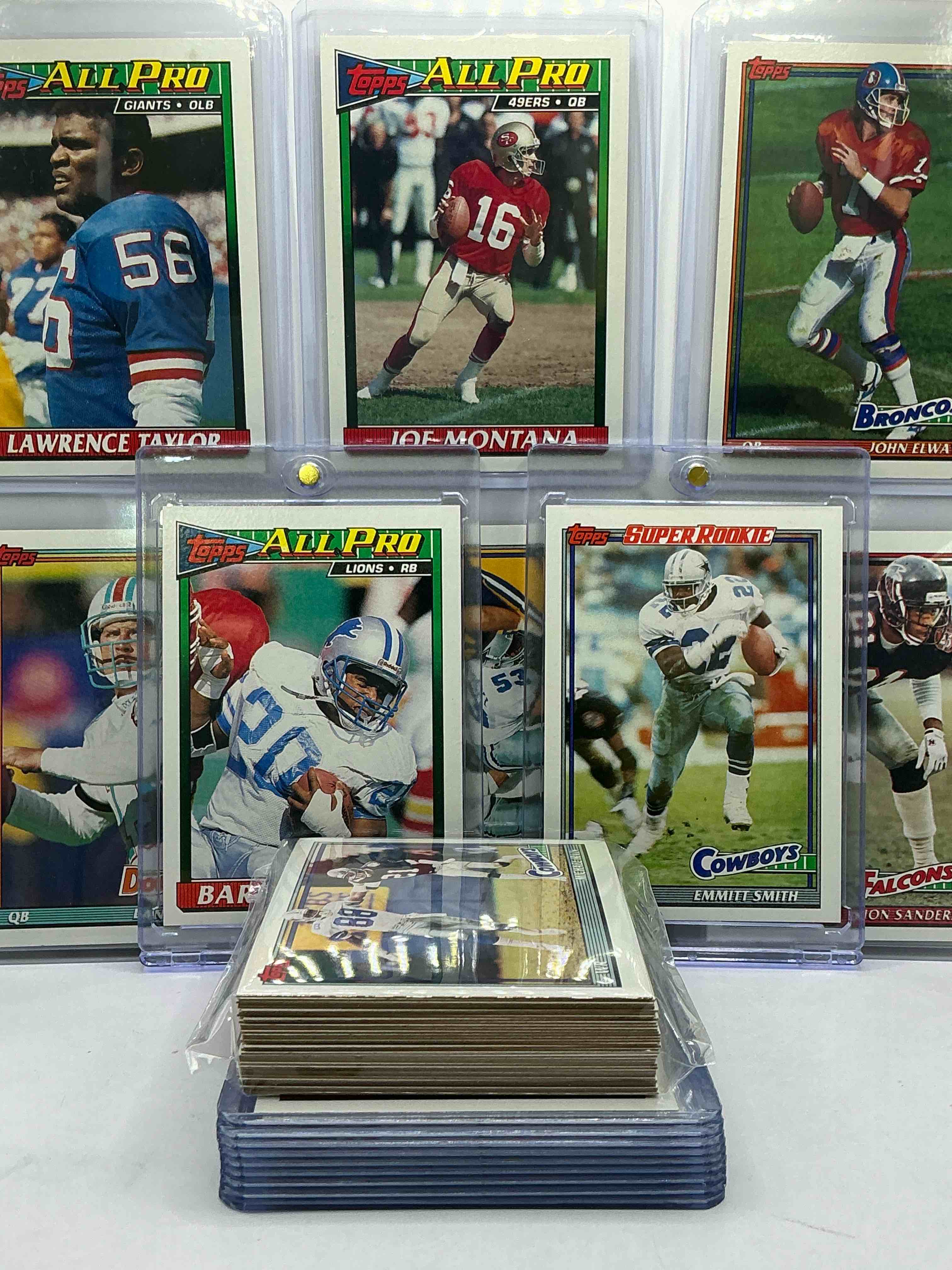 Condition photo showing New/Like New for 1991 Topps Football! Emmitt Smith Super Rookie Rookie Card, Barry Sanders Card, John Elway, Dan Marino, Lawrence Taylor, Jerry Rice & More! 1991 Topps Football 50 Card Lot! Invest In Vintage Football!