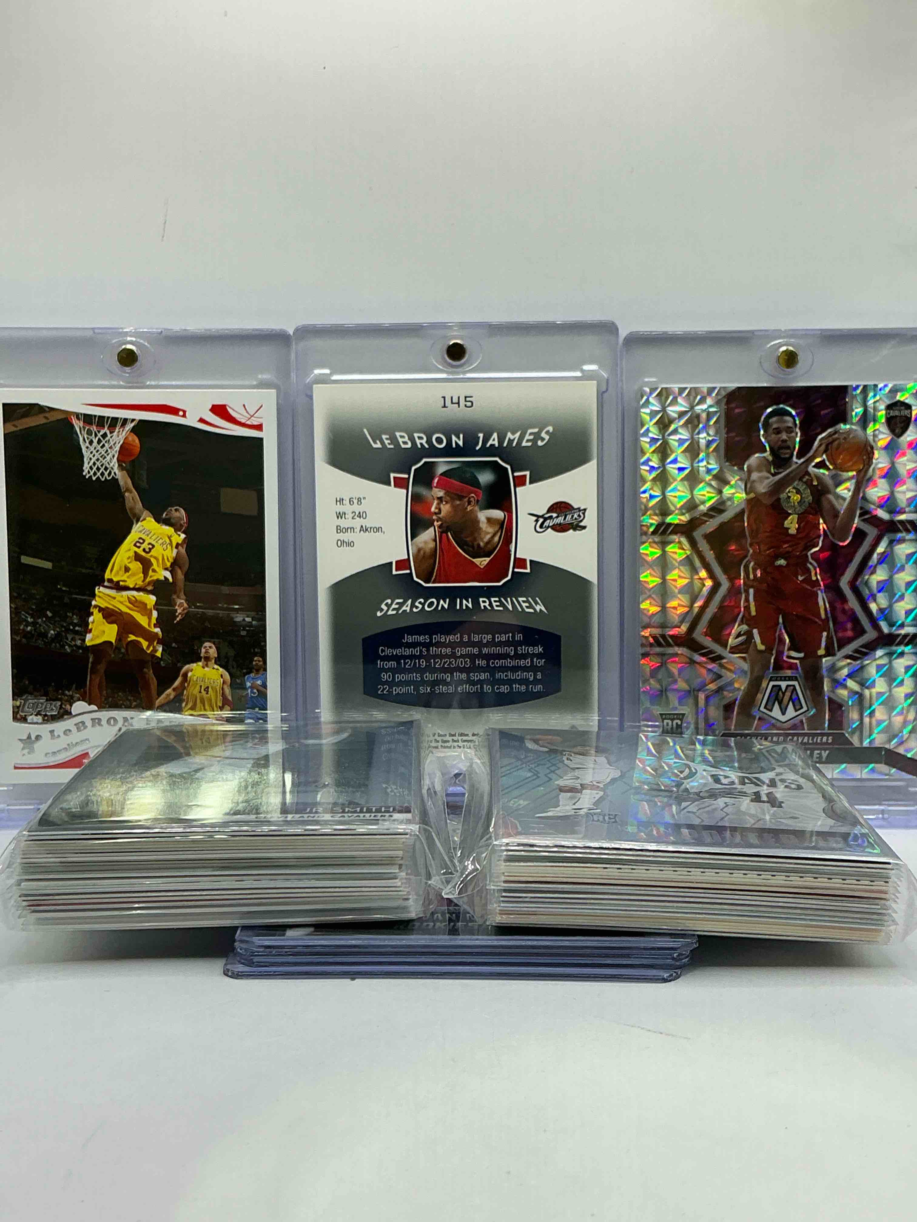 Condition photo showing New/Like New for LeBron James First Year Card /999 WOW! Super Rare! Insane Card, Mixed With Evan Mobley Silver Mosaic Rookie, LeBron Card & More! WOW! Cavaliers Craziness! This 50 Card Lot Is Filled With Commons, Legends, Heroes & More!