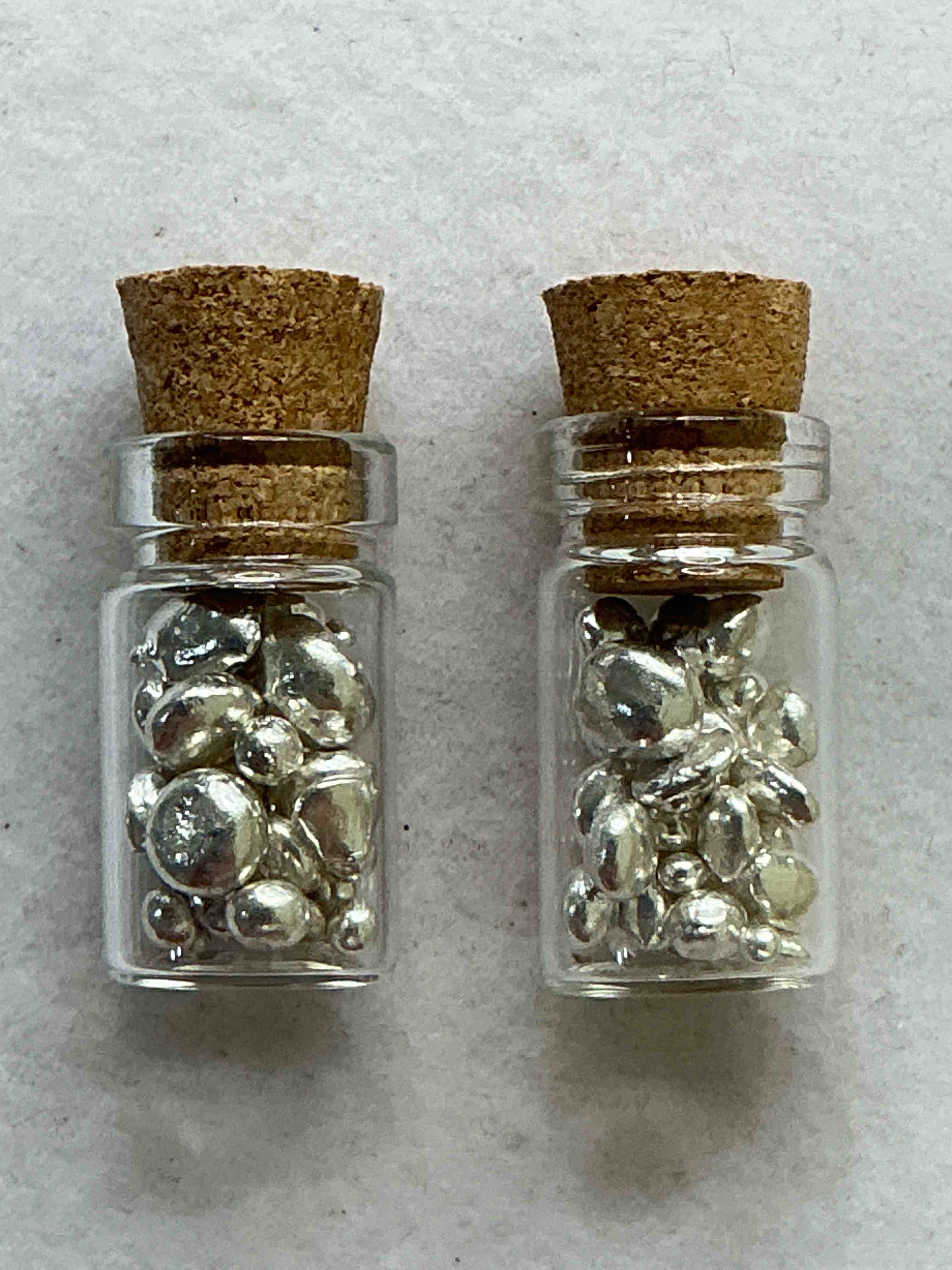 Condition photo showing Good Condition for  bid is per nugget glass is broken silver nuggets! .999 us fine silver, in small nugget form! total weight of all nuggets in lot approximately 6 grams, bid is per nugget! a cool way to invest in fine us silver! includes collector capsule!