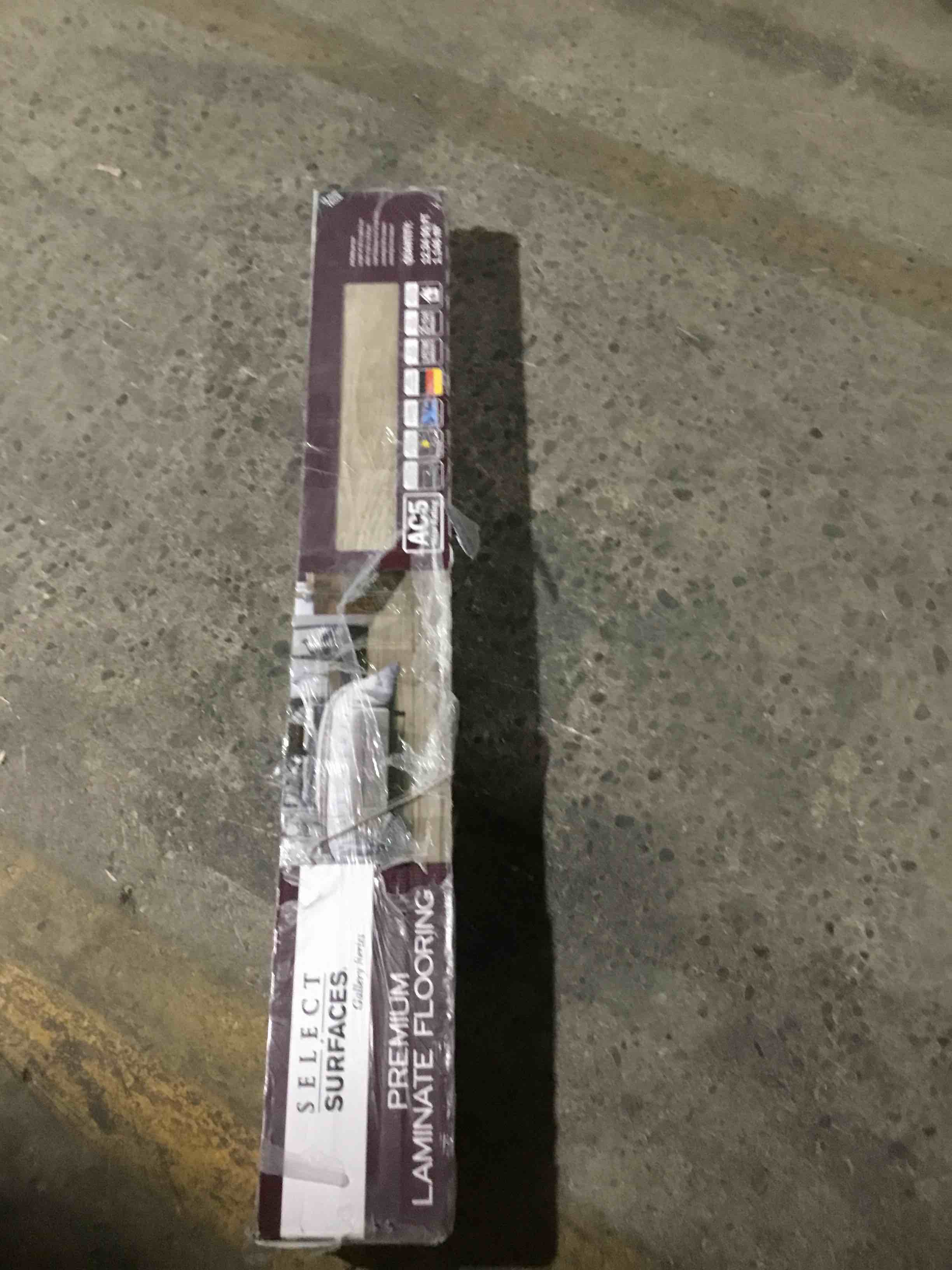 Select Surfaces®’ Aspen laminate flooring offers a warm-toned greige color that blends gray and beige hues with subtle taupe undertones, creating a soft, inviting look that suits a variety of interior styles