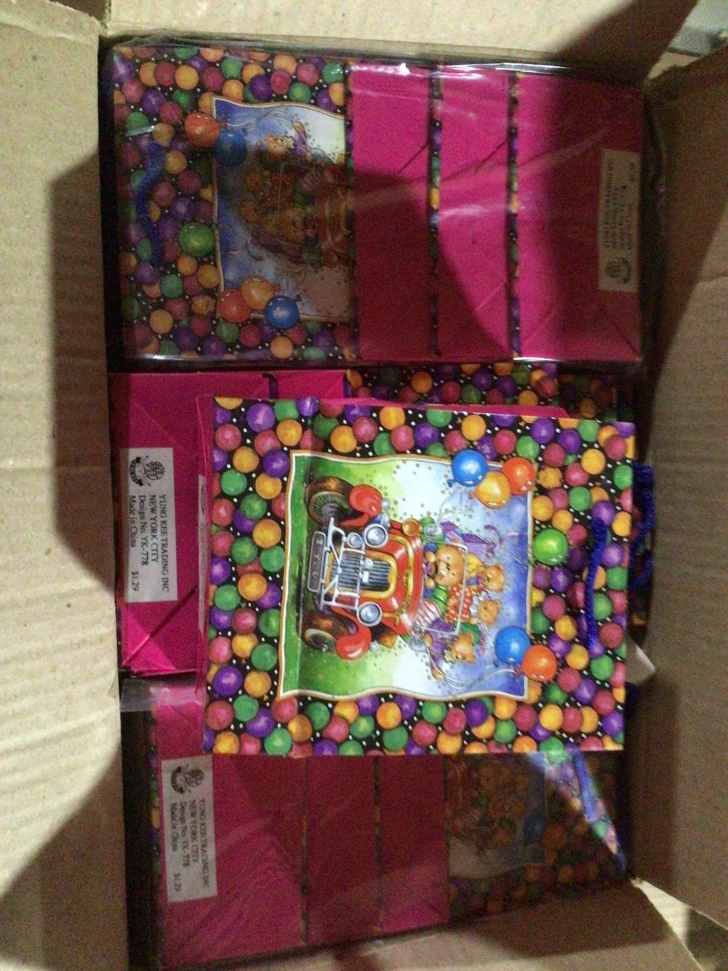 paper gift with a design of teddy bears in an old car