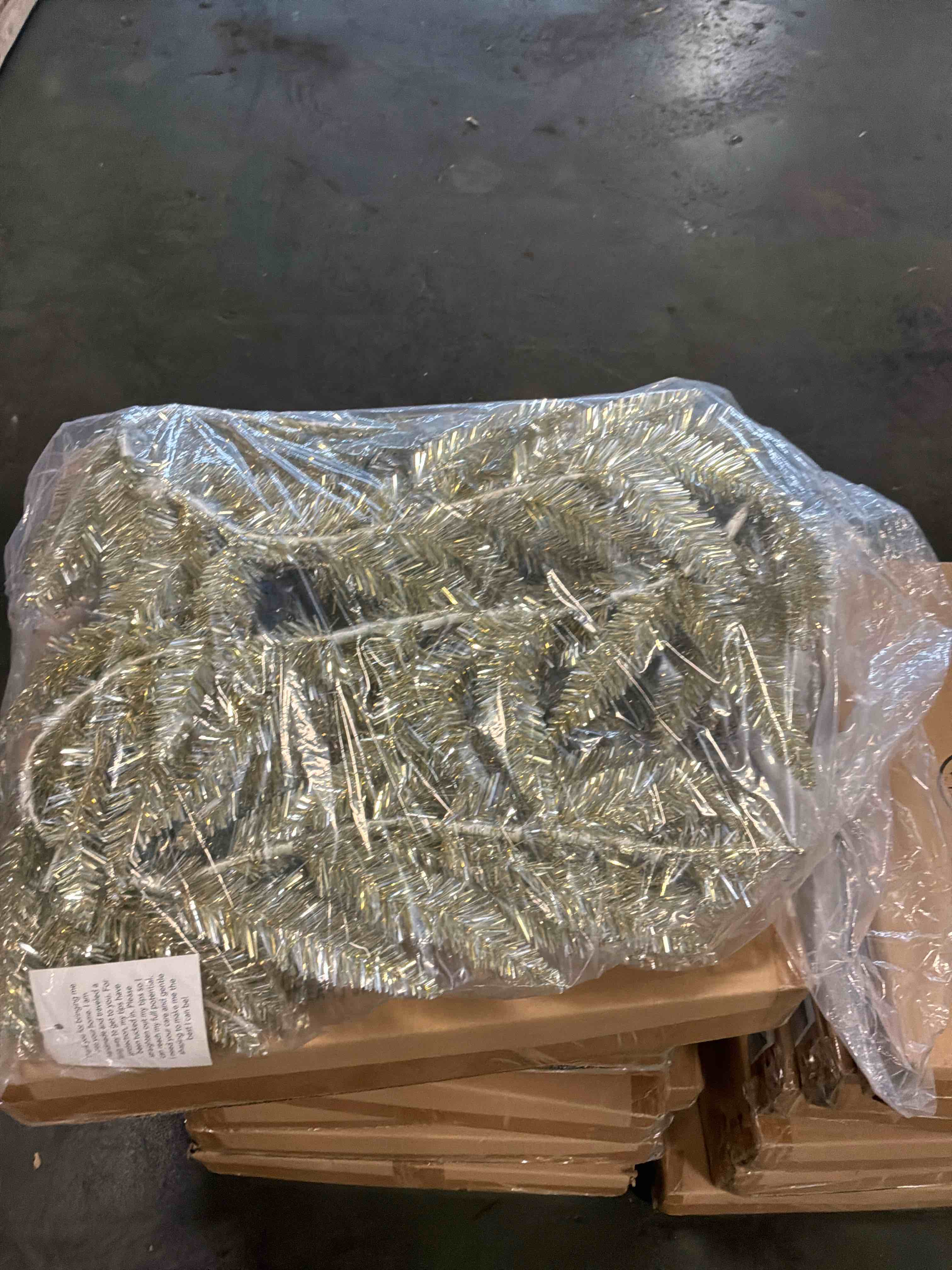 Condition photo showing New/Like New for 6’ pre lit champagne tinsel garland 