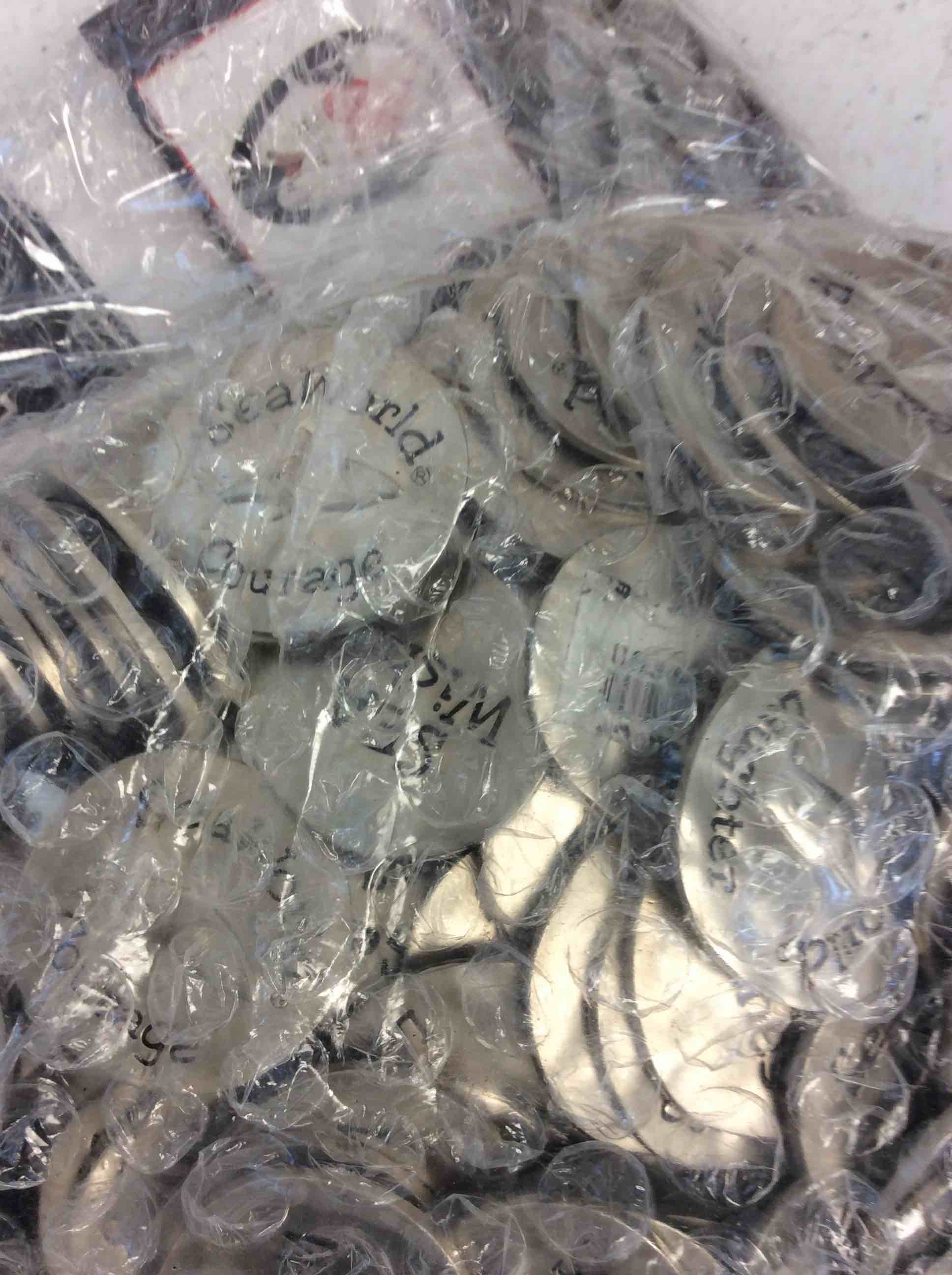 Condition photo showing New/Like New for bag of seaworld courage coins 