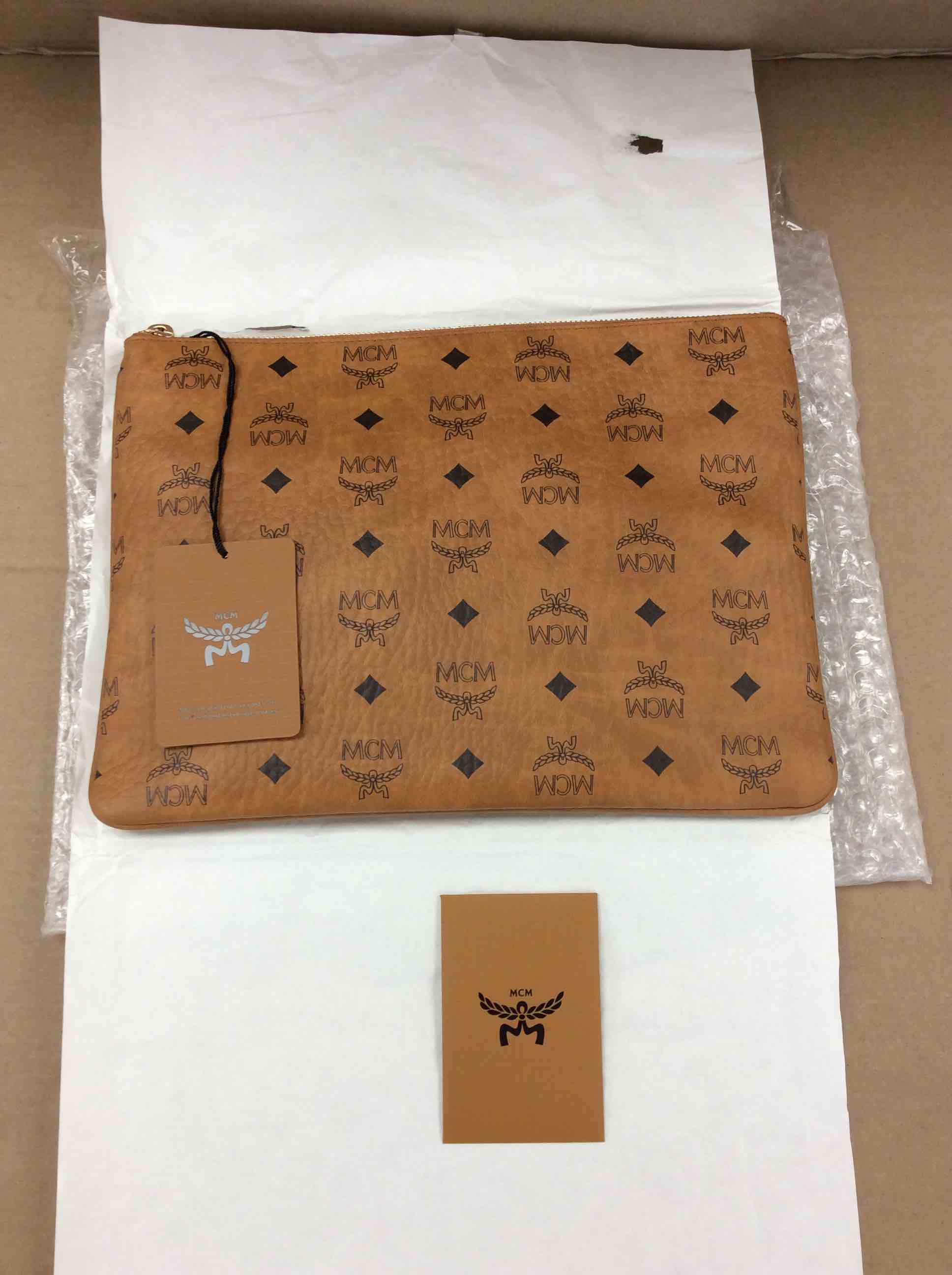 Condition photo showing New/Like New for mcm visetos original pouch in cognac