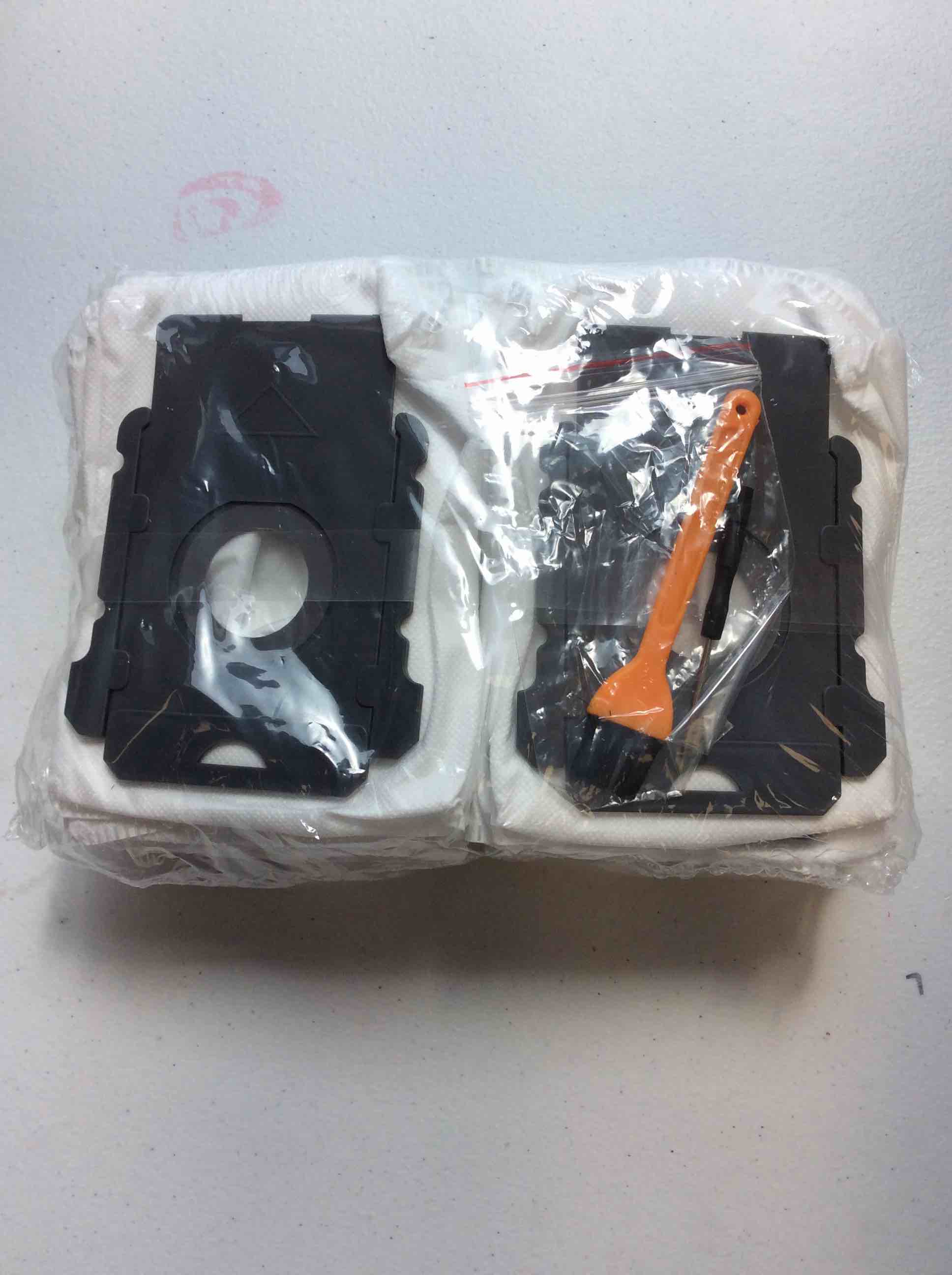 A Set of White Synthetic Vacuum Bags with Black Plastic Collars