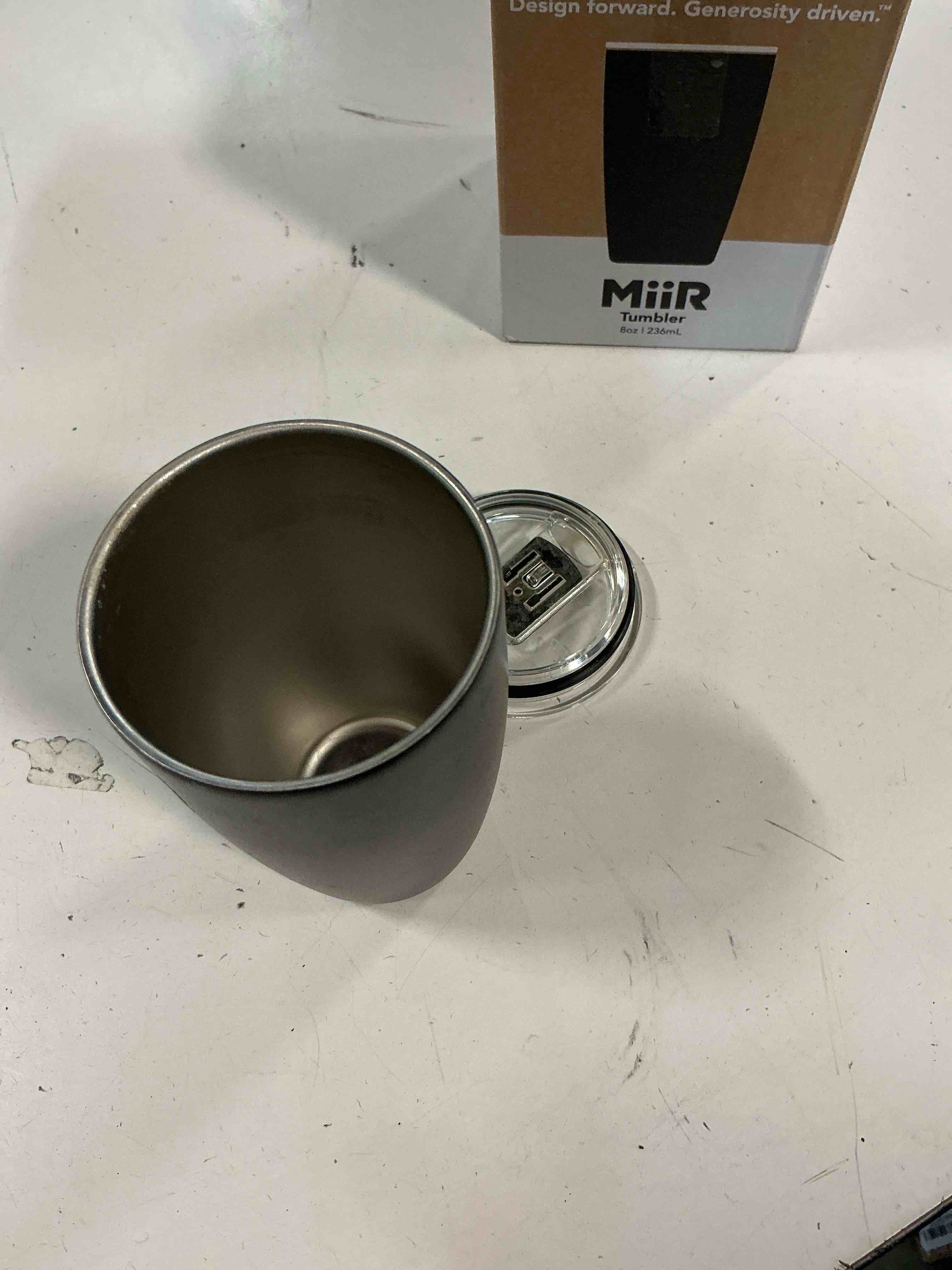 Condition photo showing As Is for miir tumbler, 12oz insulated stainless steel with press fit slide lid – splash proof design, holds hot & cold beverages, stylish & functional cup holder compatible