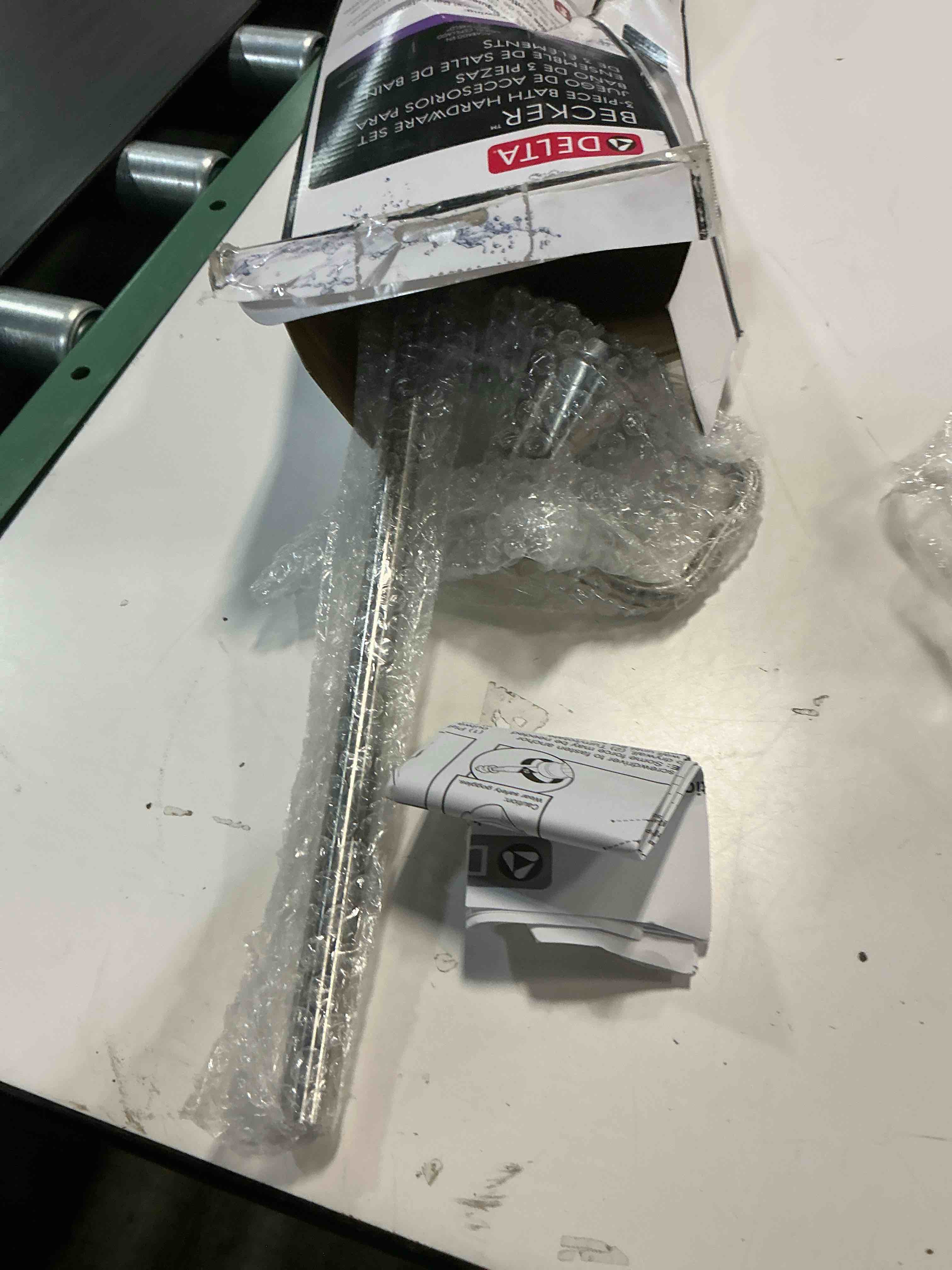 Condition photo showing As Is for delta faucet becker 3-piece bathroom set, spotshield brushed nickel, 18"/24" towel rack, toilet paper holder, ring bck63-dn