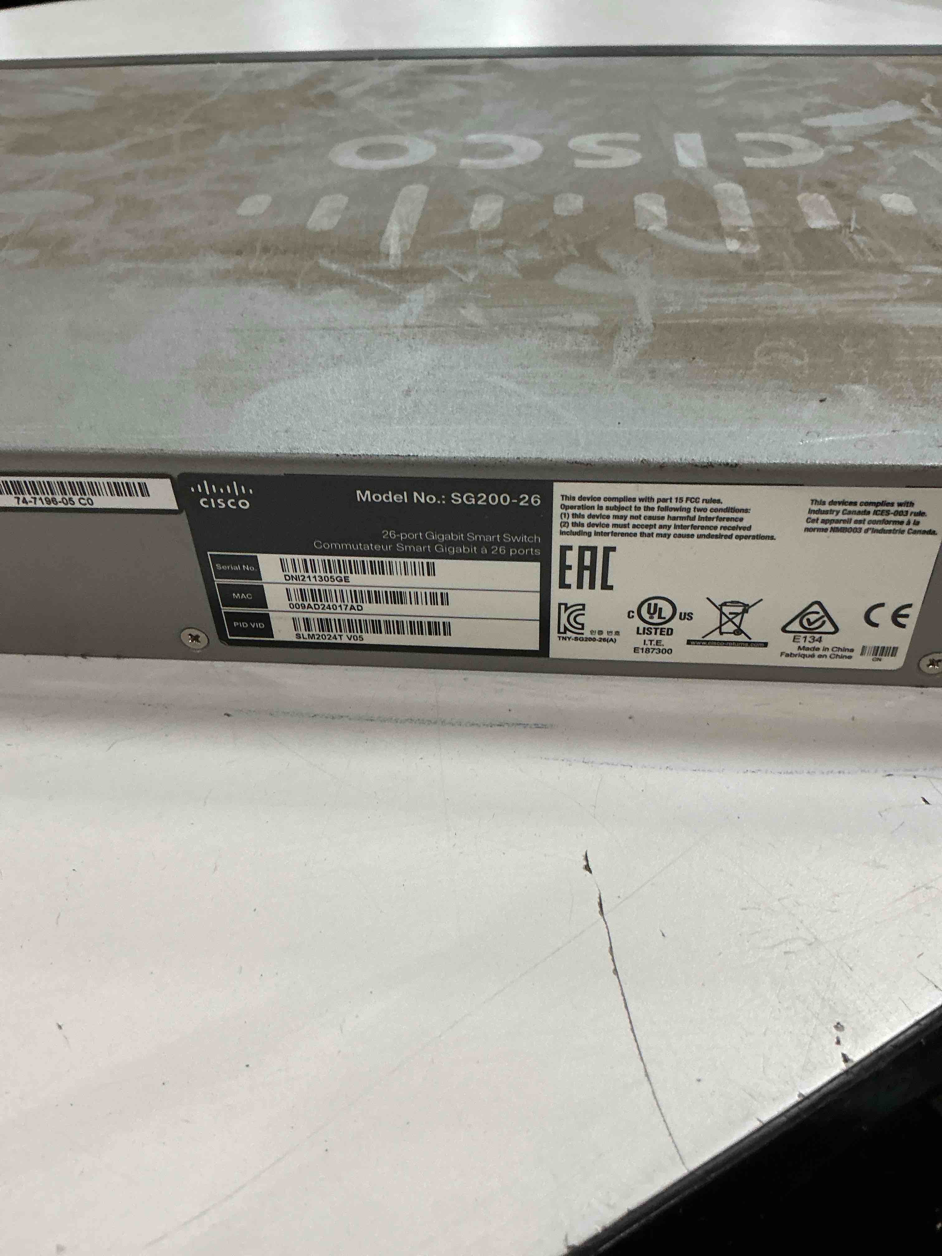 Condition photo showing As Is for cisco designed sg200-26 gigabit ethernet smart switch with 24 10/100/1000 ports and 2 combo mini-gbic ports (slm2024t-na), one size